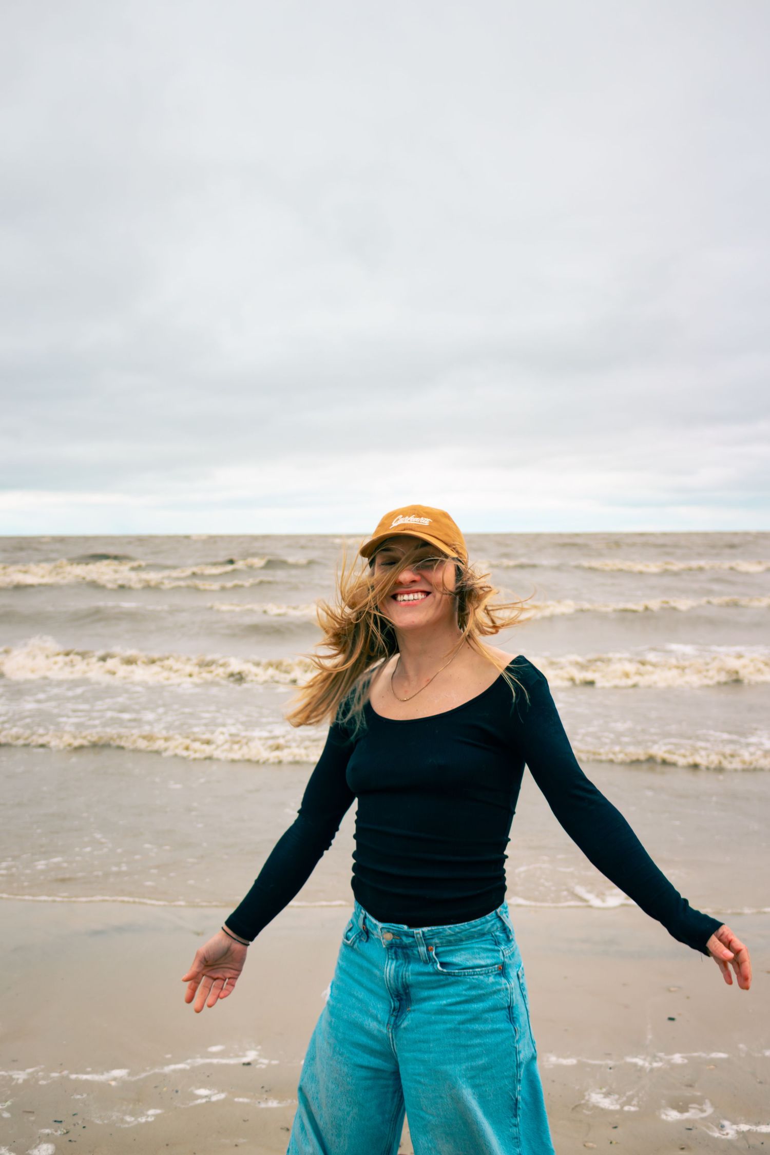 young woman posing at the beach