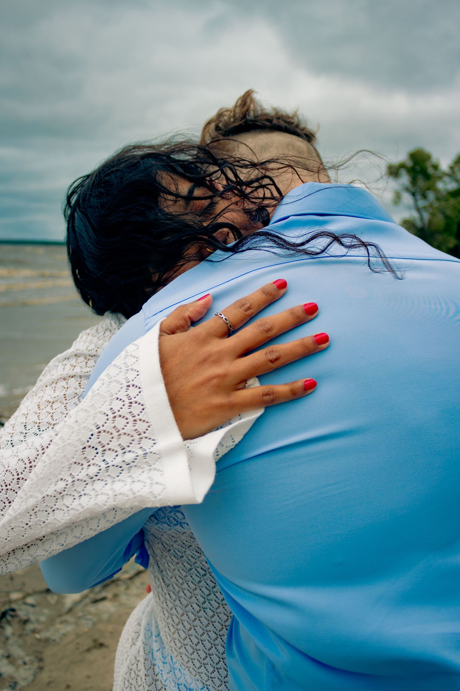 young couple posing at the beach
