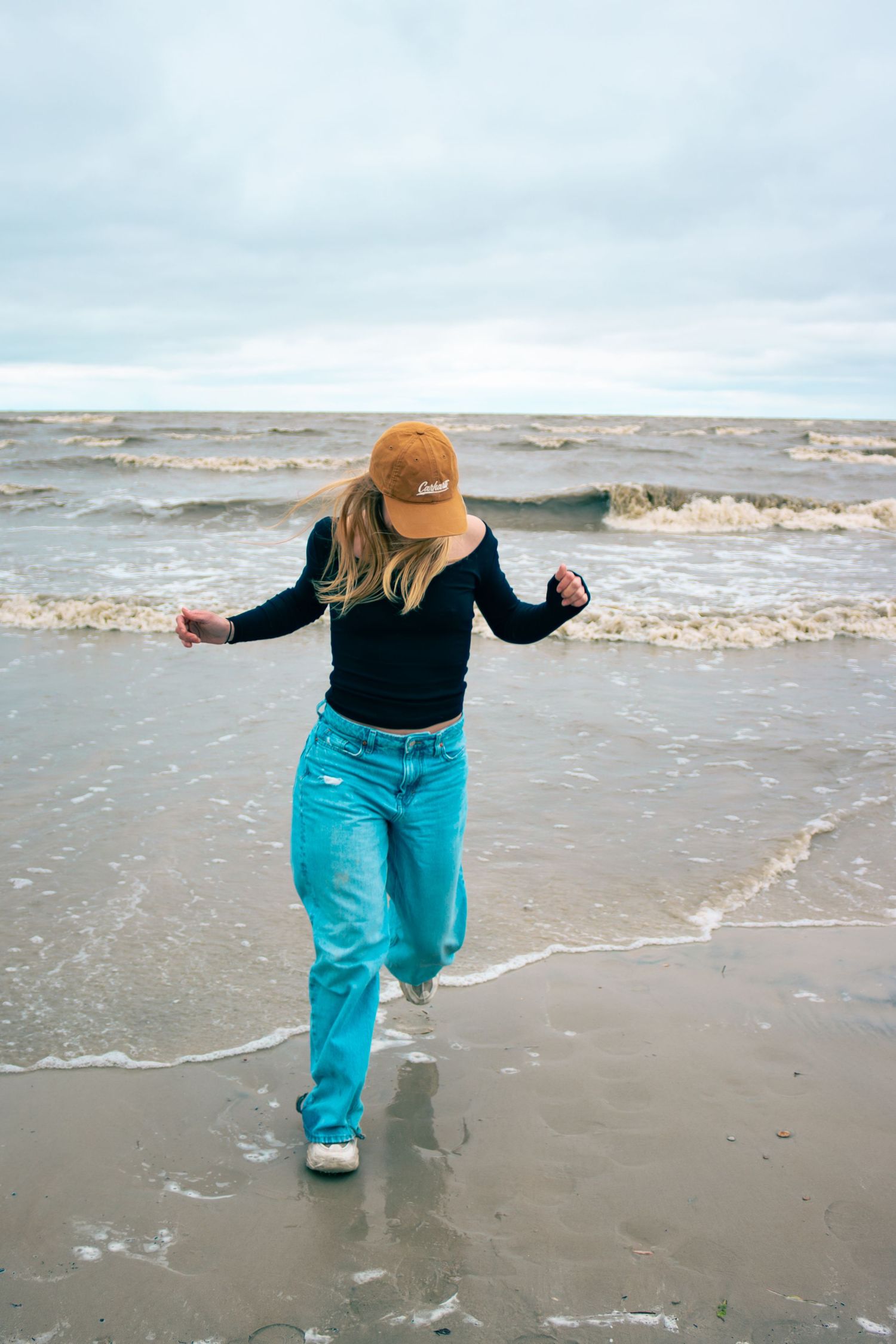 young woman posing at the beach
