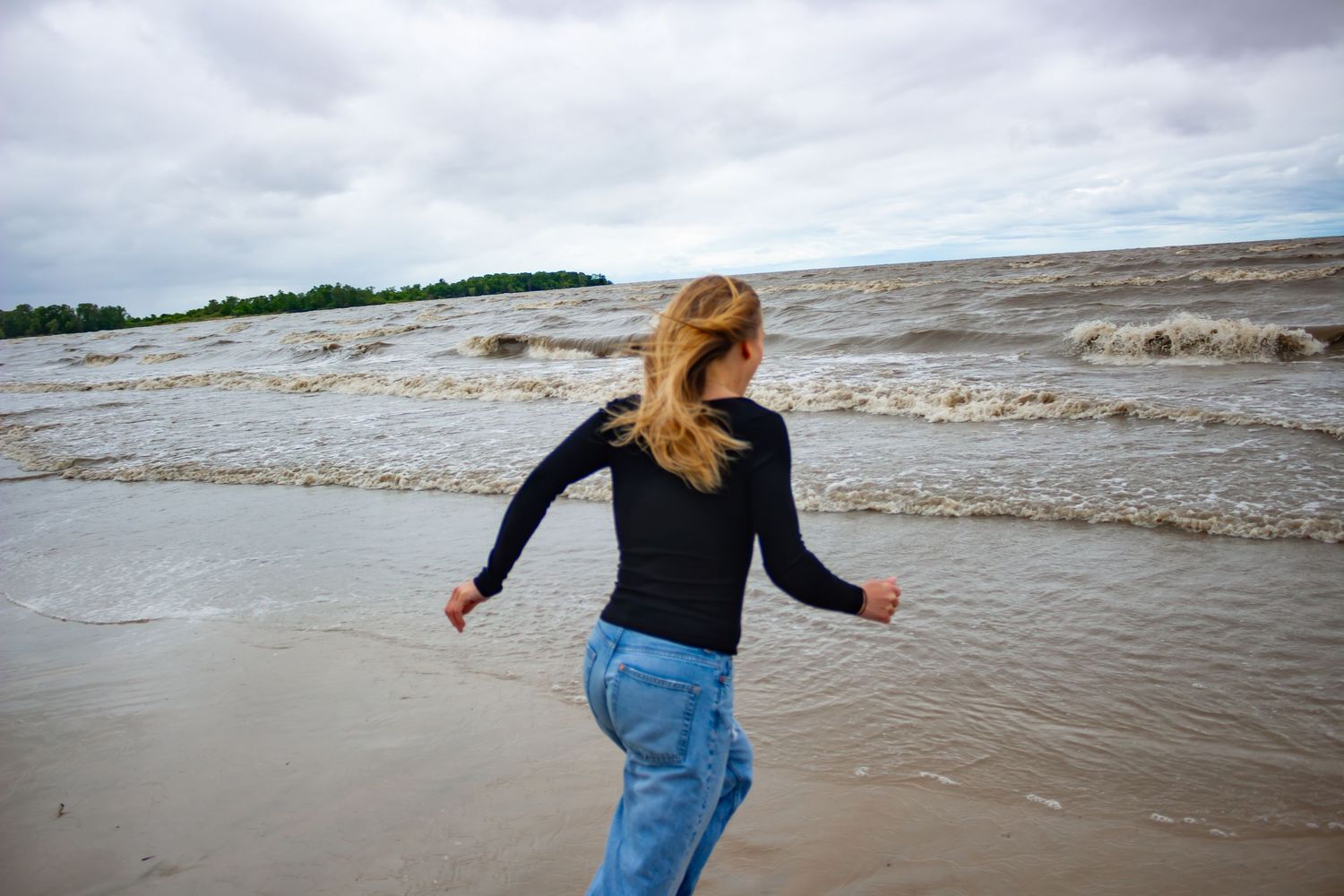 young woman posing at the beach