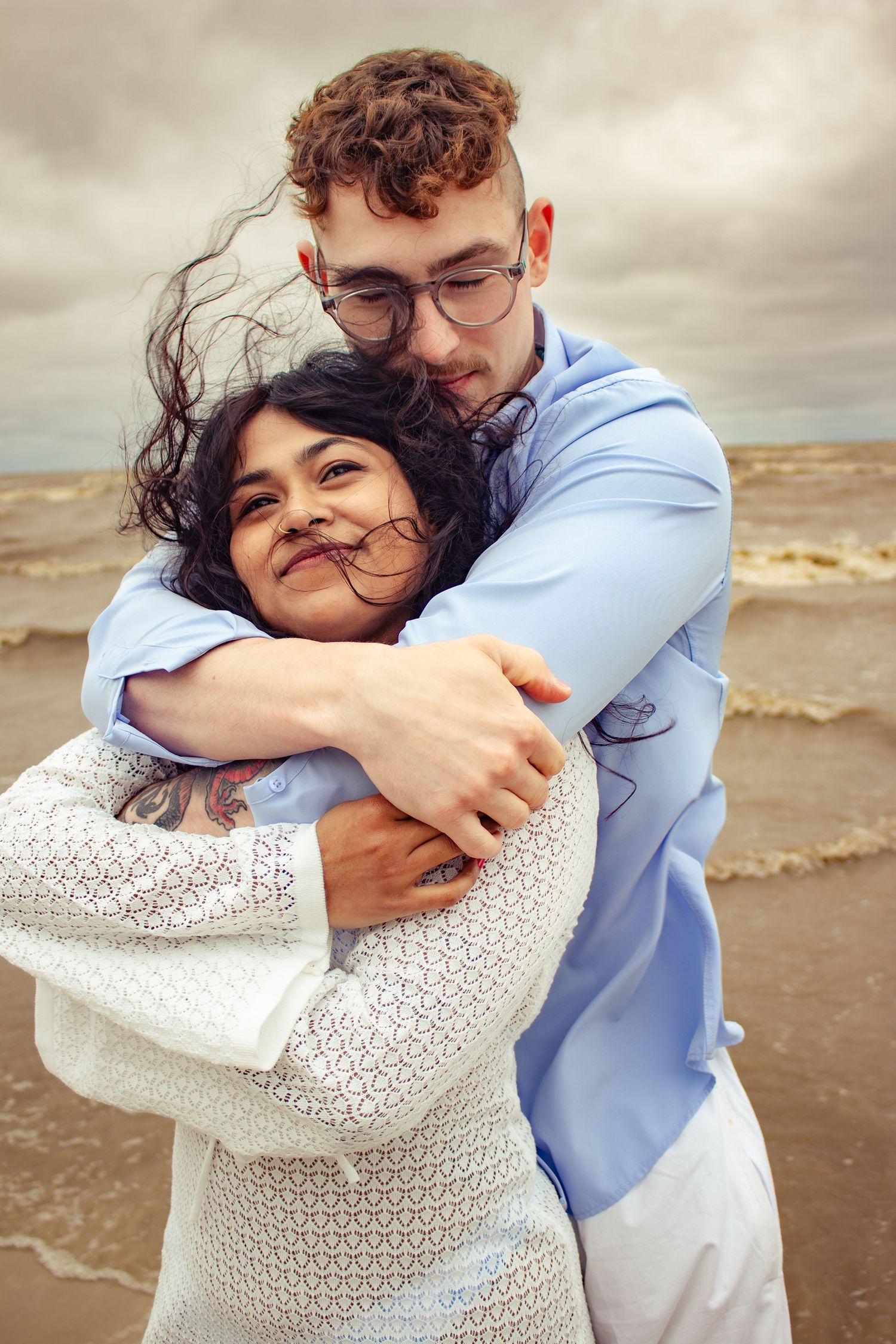 young couple posing at the beach