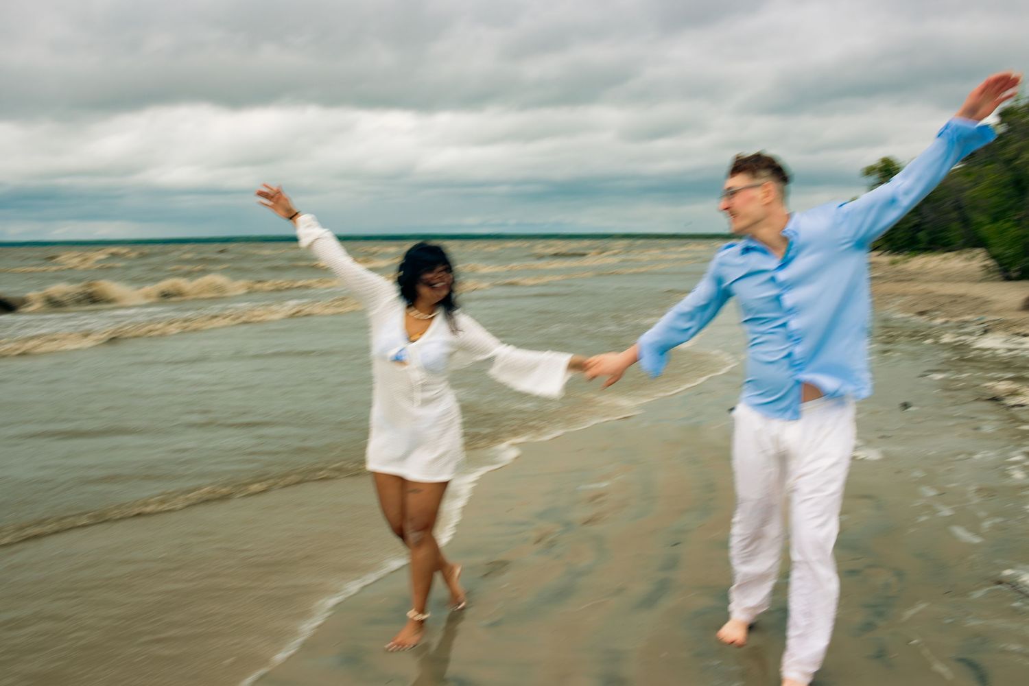 young couple posing at the beach