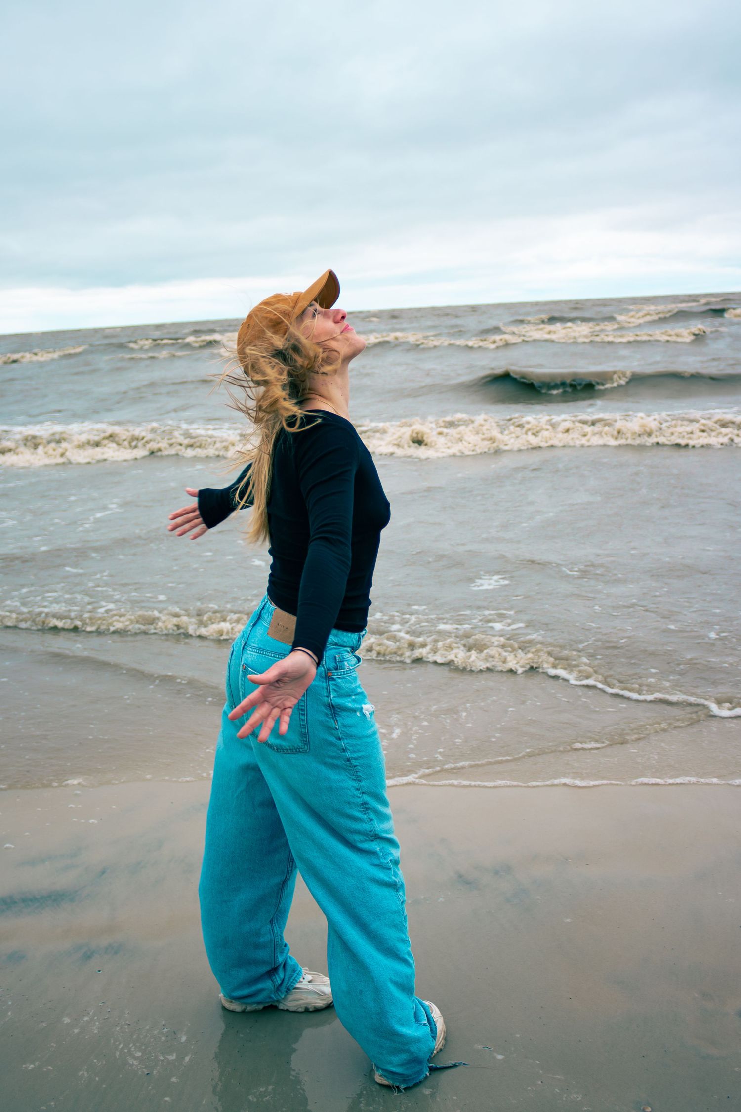 young woman posing at the beach
