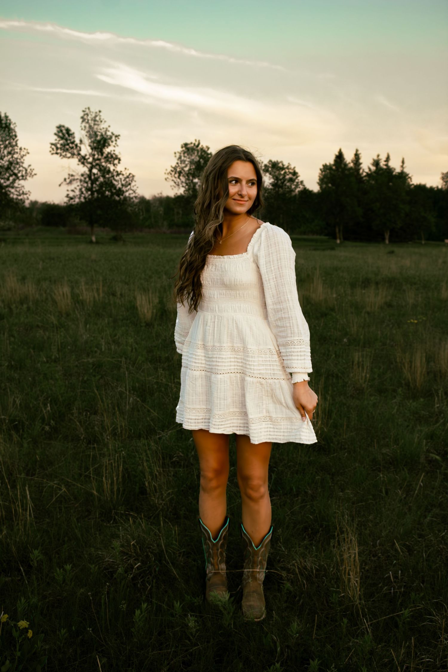 young woman in a field smiling