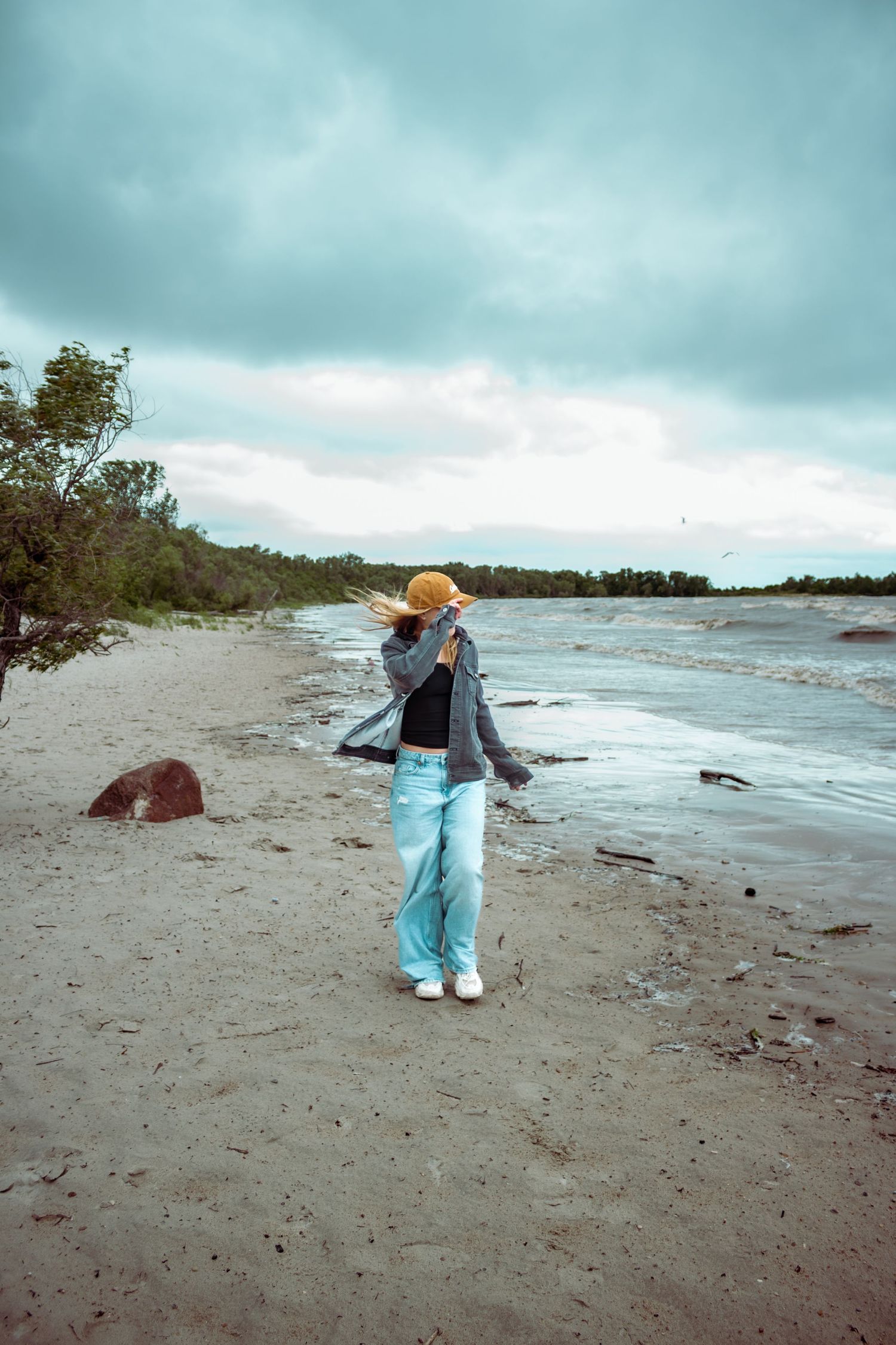 young woman posing at the beach