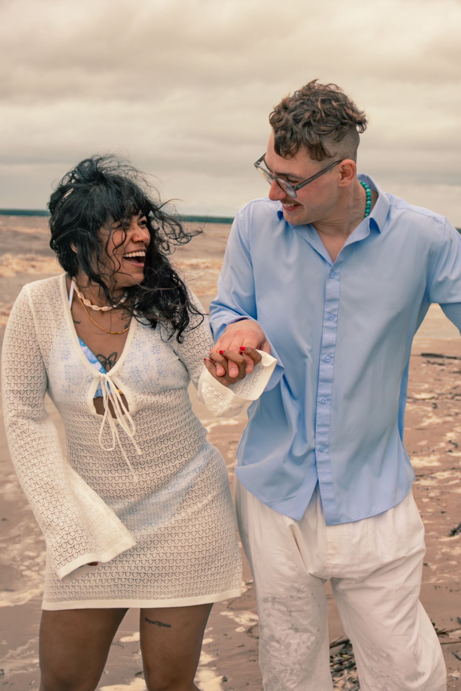 young couple posing at the beach