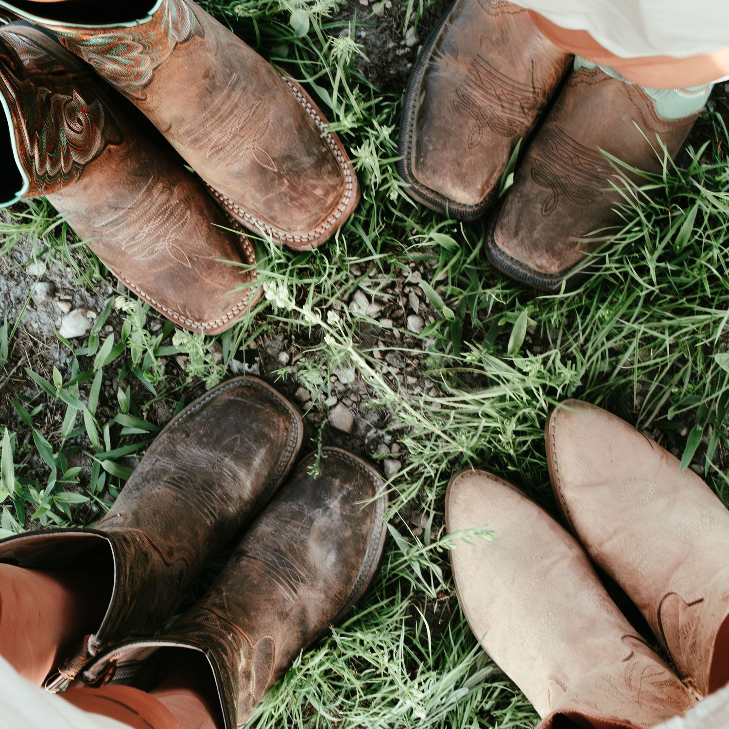 four pairs of cowboy boots situated in a circle