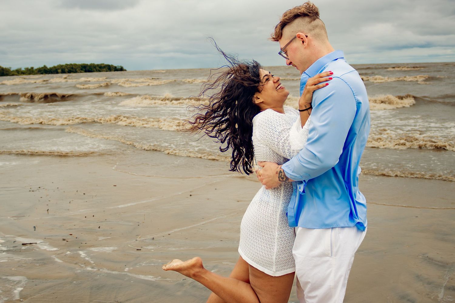 young couple posing at the beach
