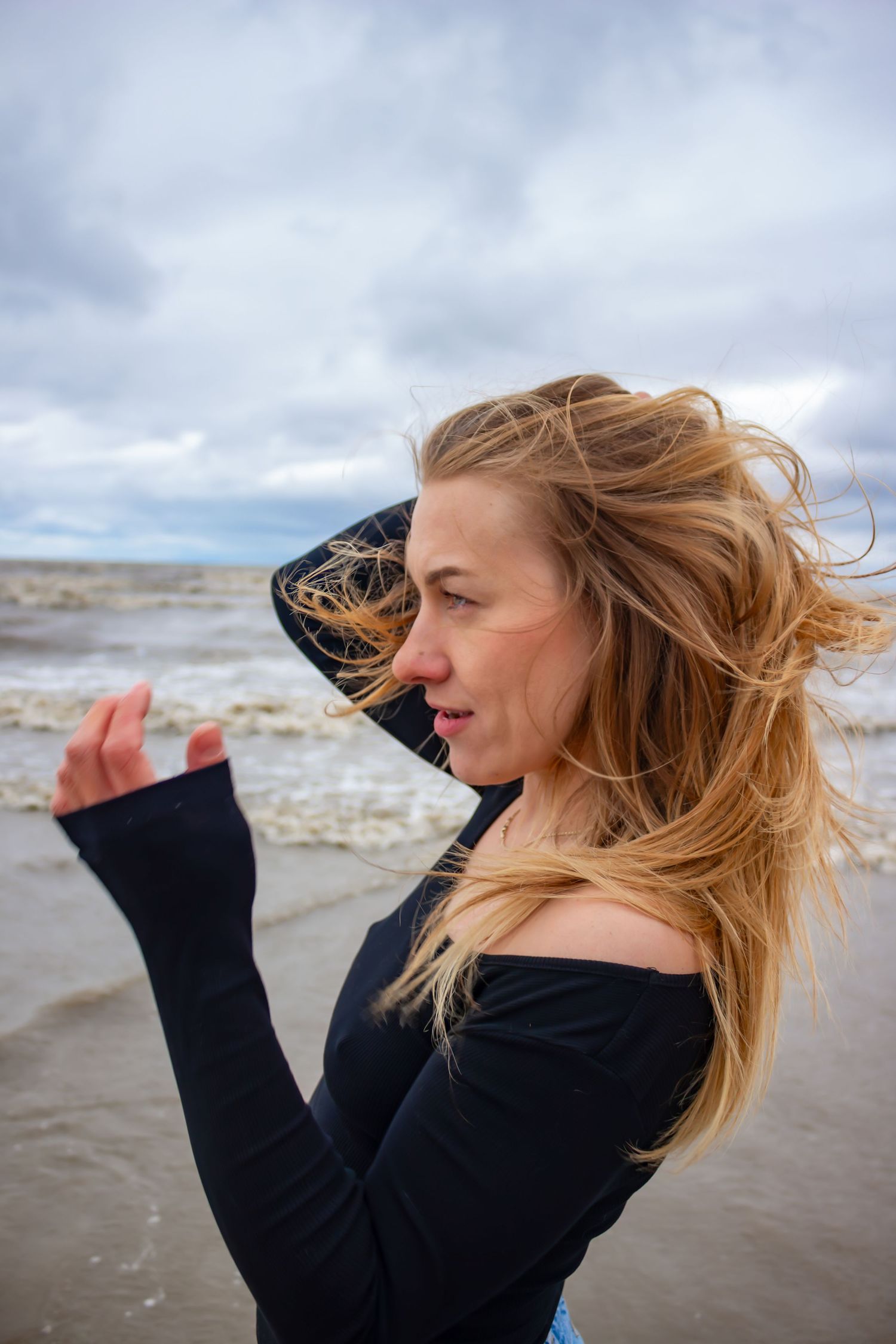 young woman posing at the beach