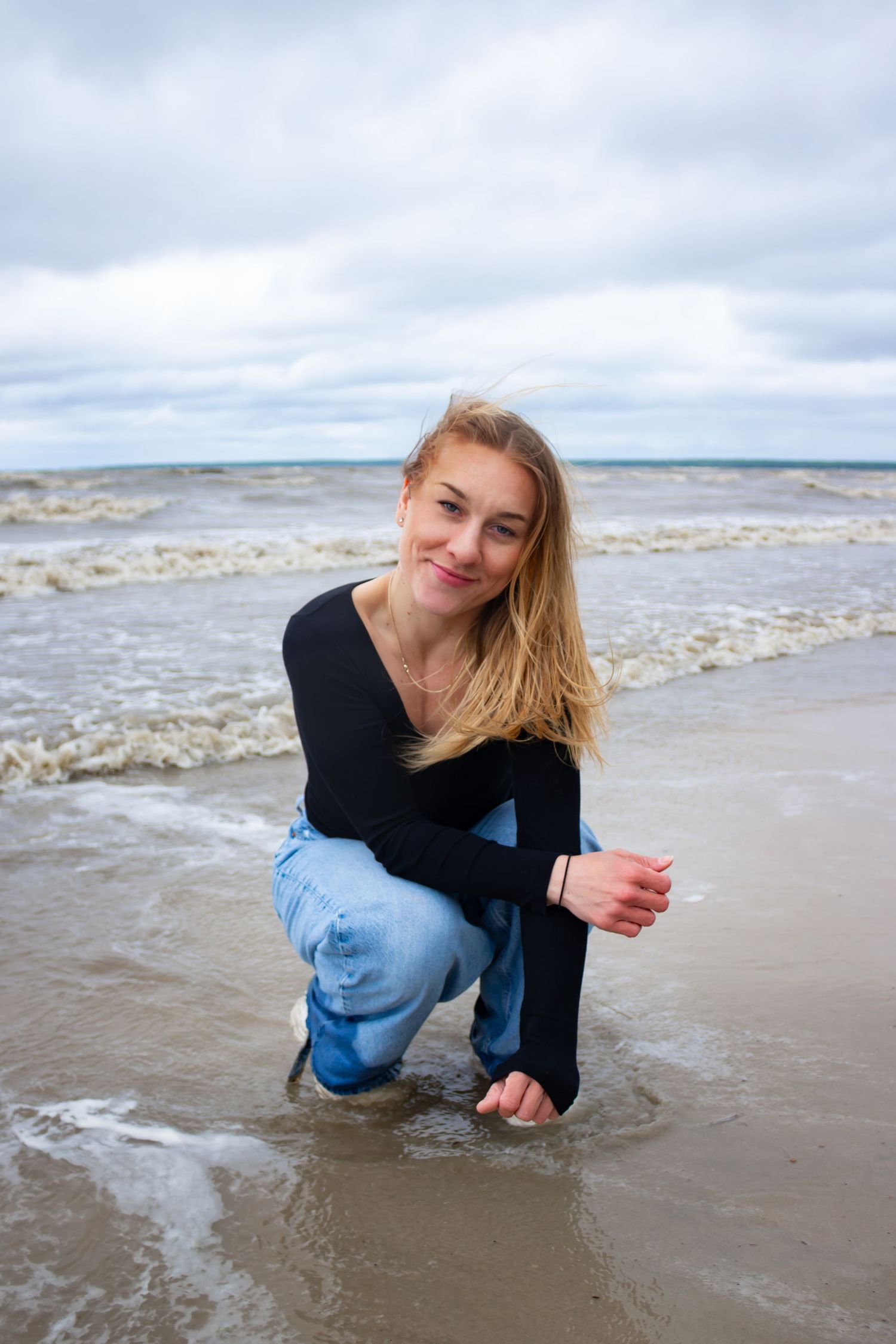 young woman posing at the beach
