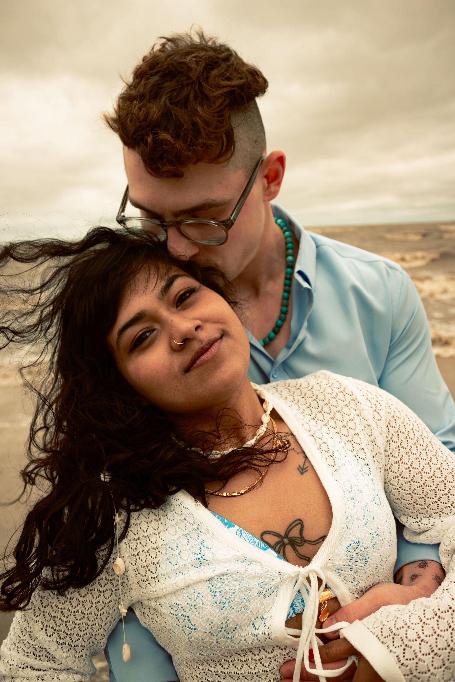 young couple posing at the beach