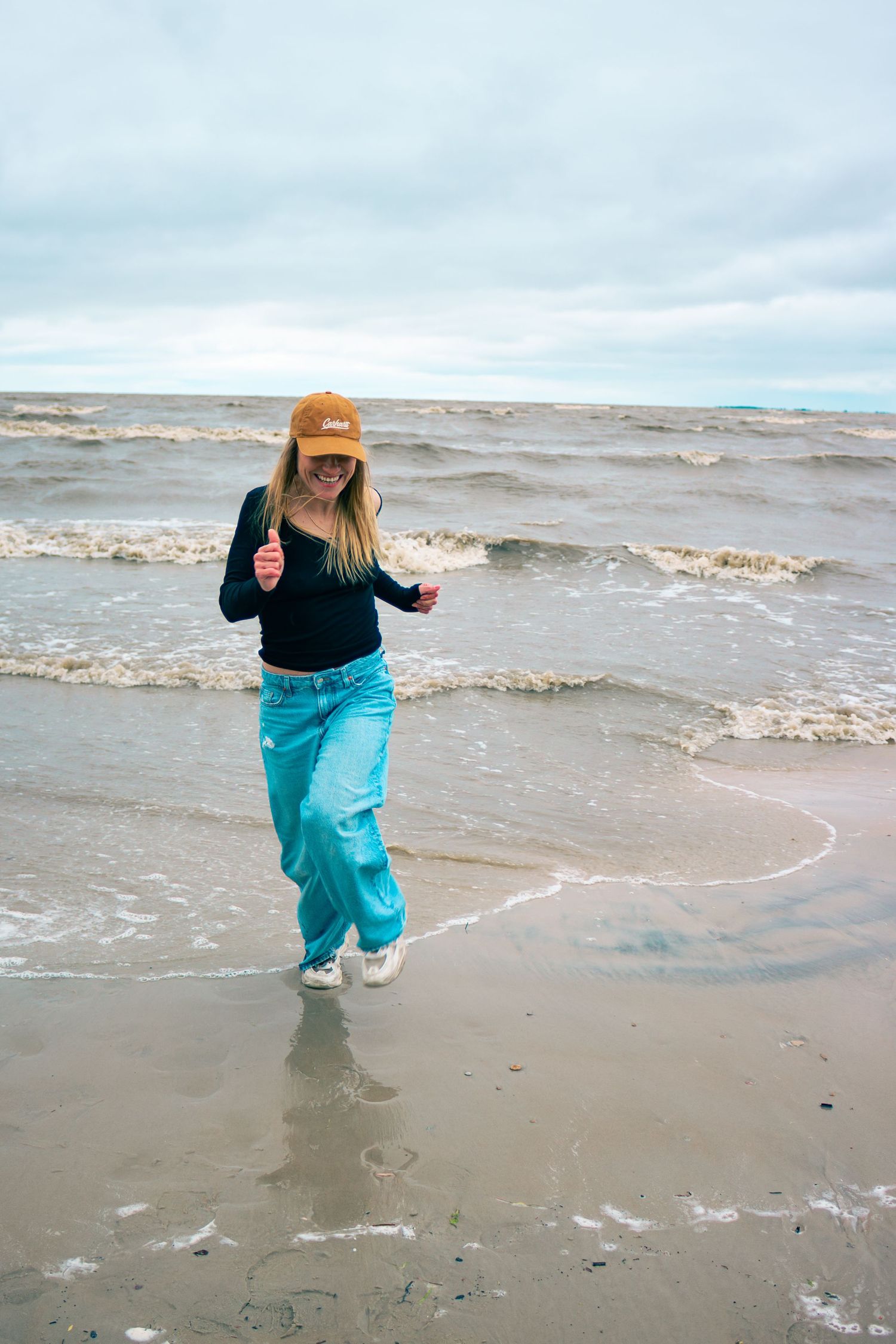 young woman posing at the beach