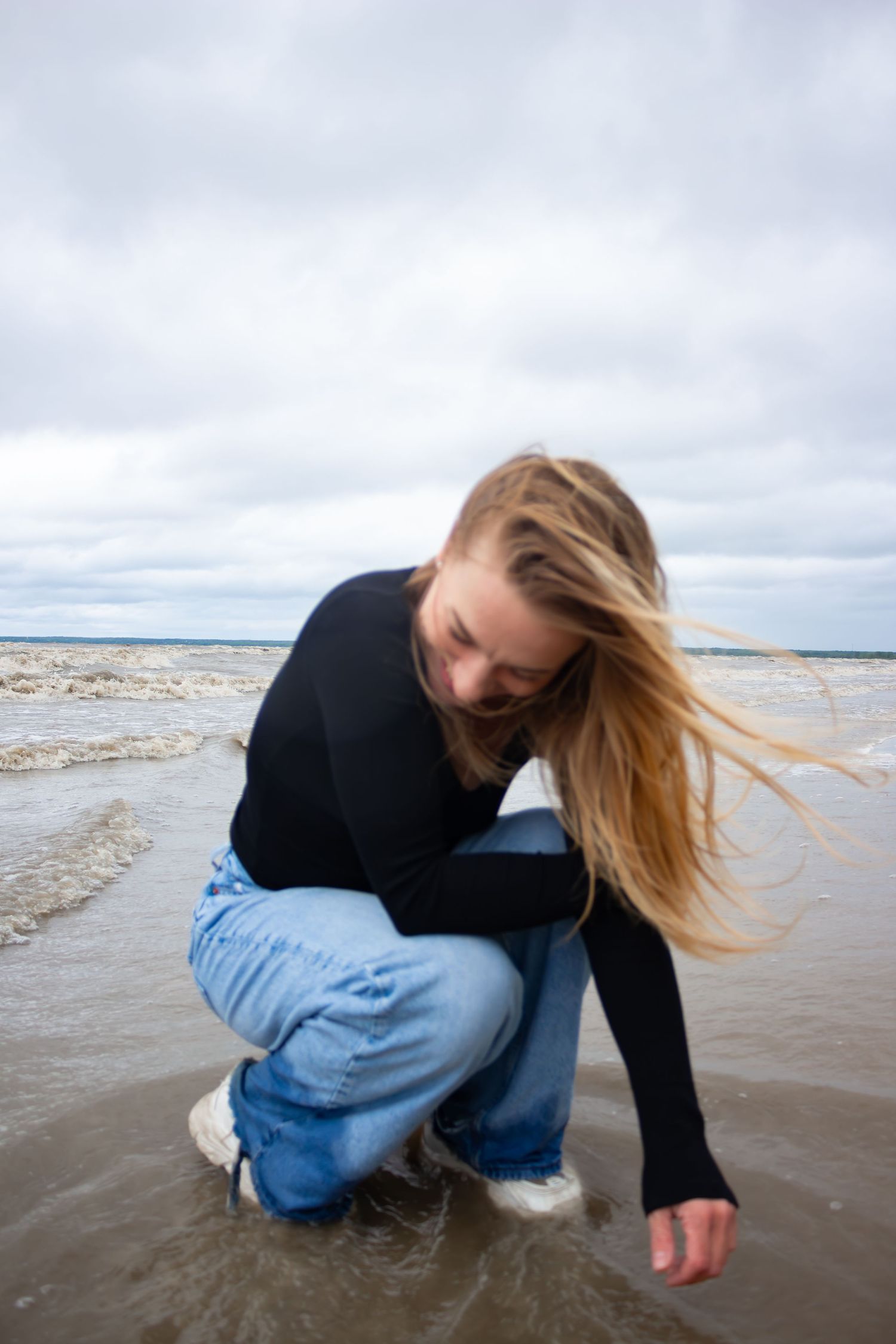 young woman posing at the beach