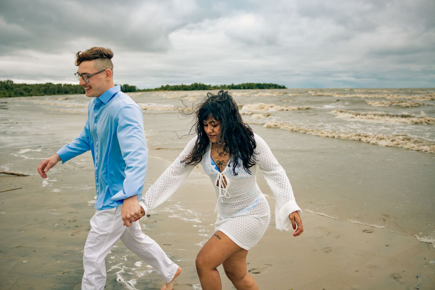 young couple posing at the beach