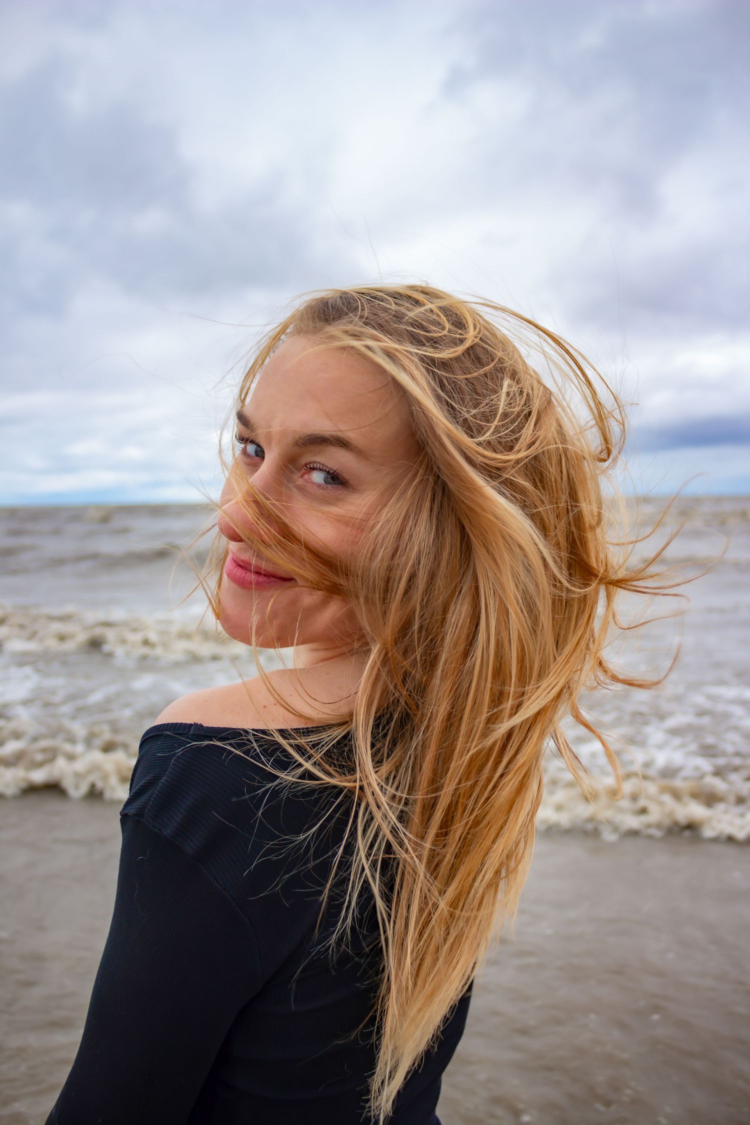 young woman posing at the beach