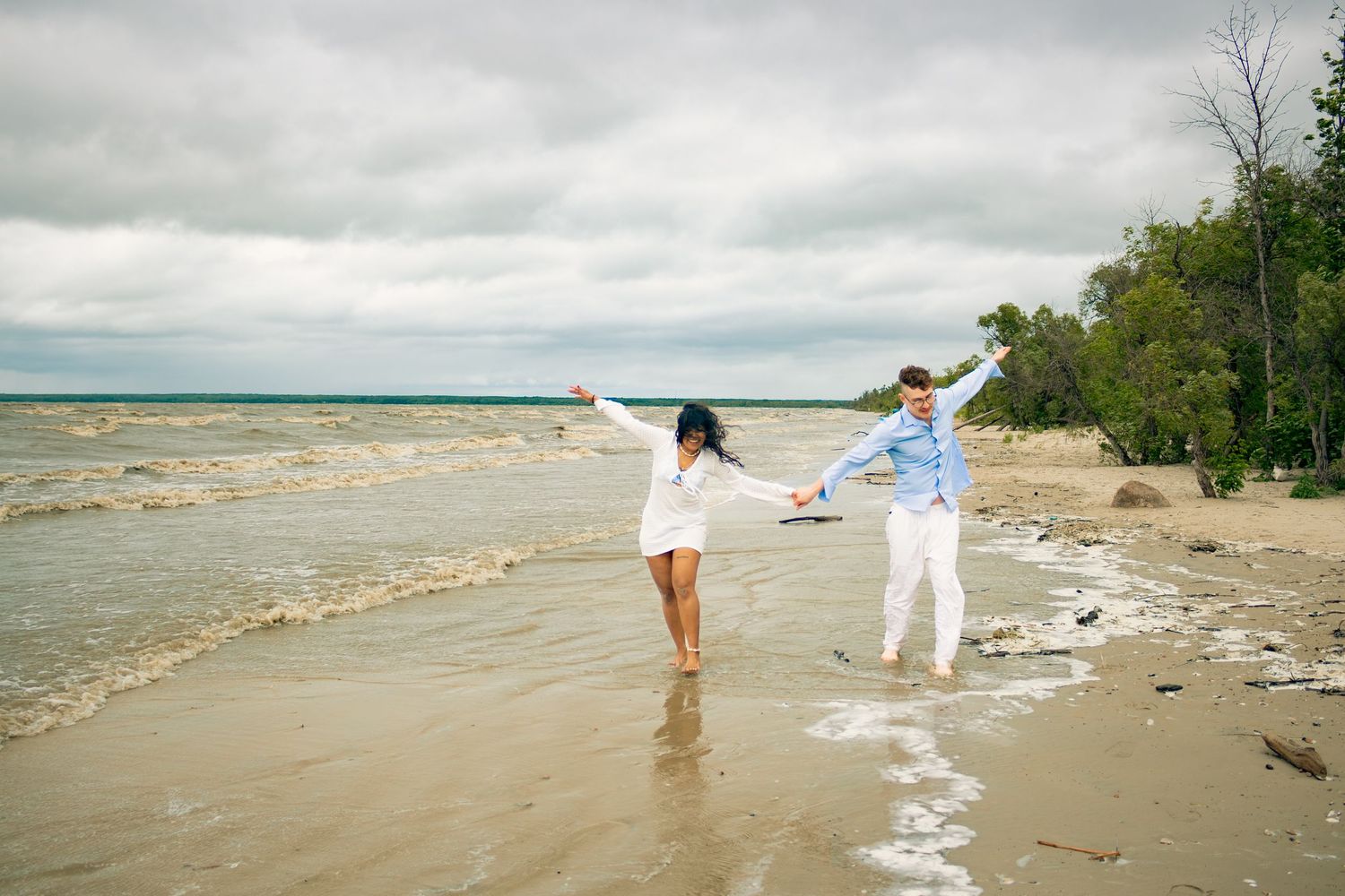 young couple posing at the beach