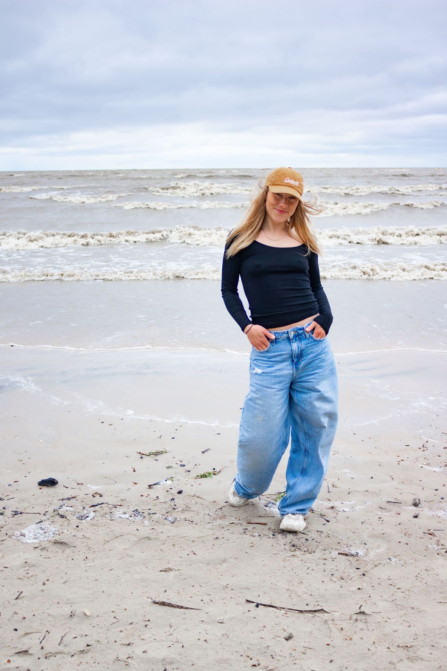 young woman posing at the beach