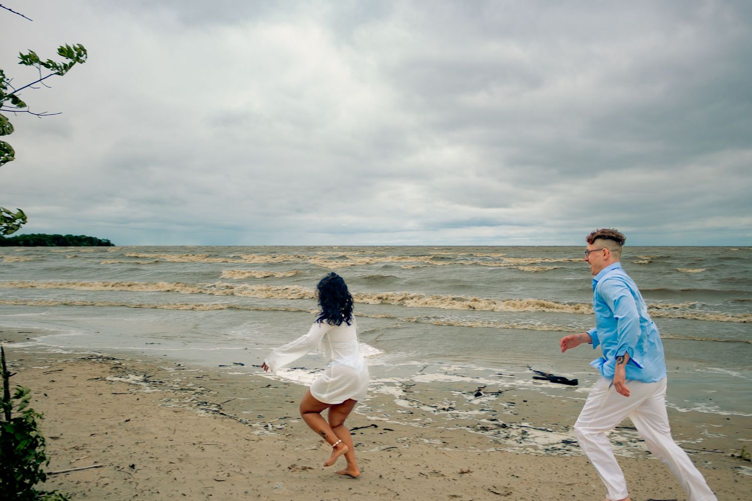 young couple posing at the beach