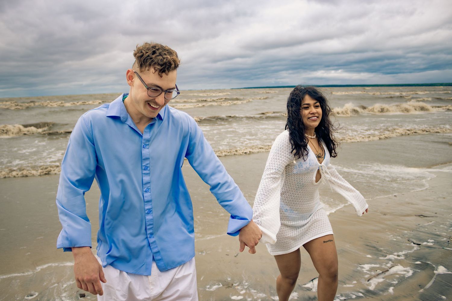 young couple posing at the beach