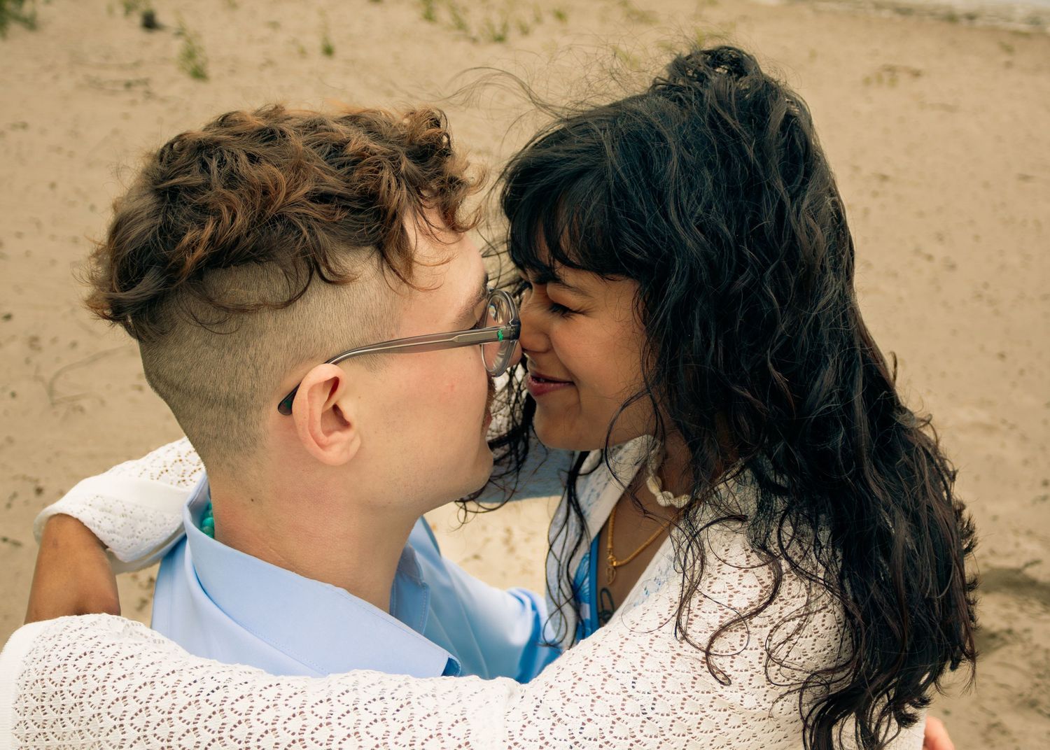 young couple posing at the beach