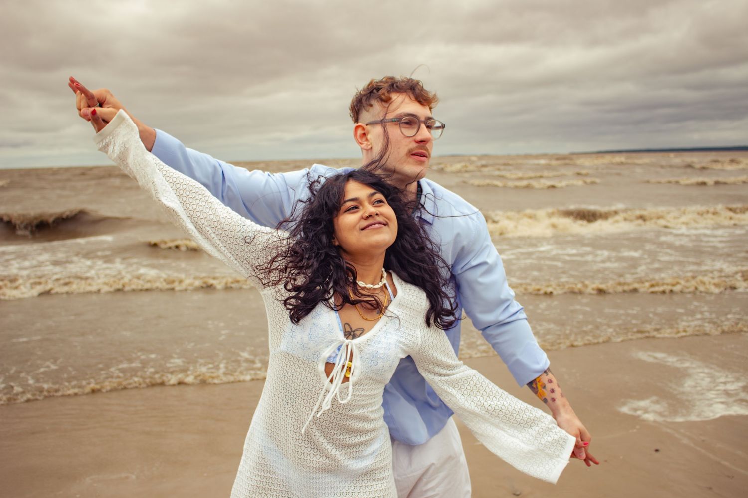 young couple posing at the beach