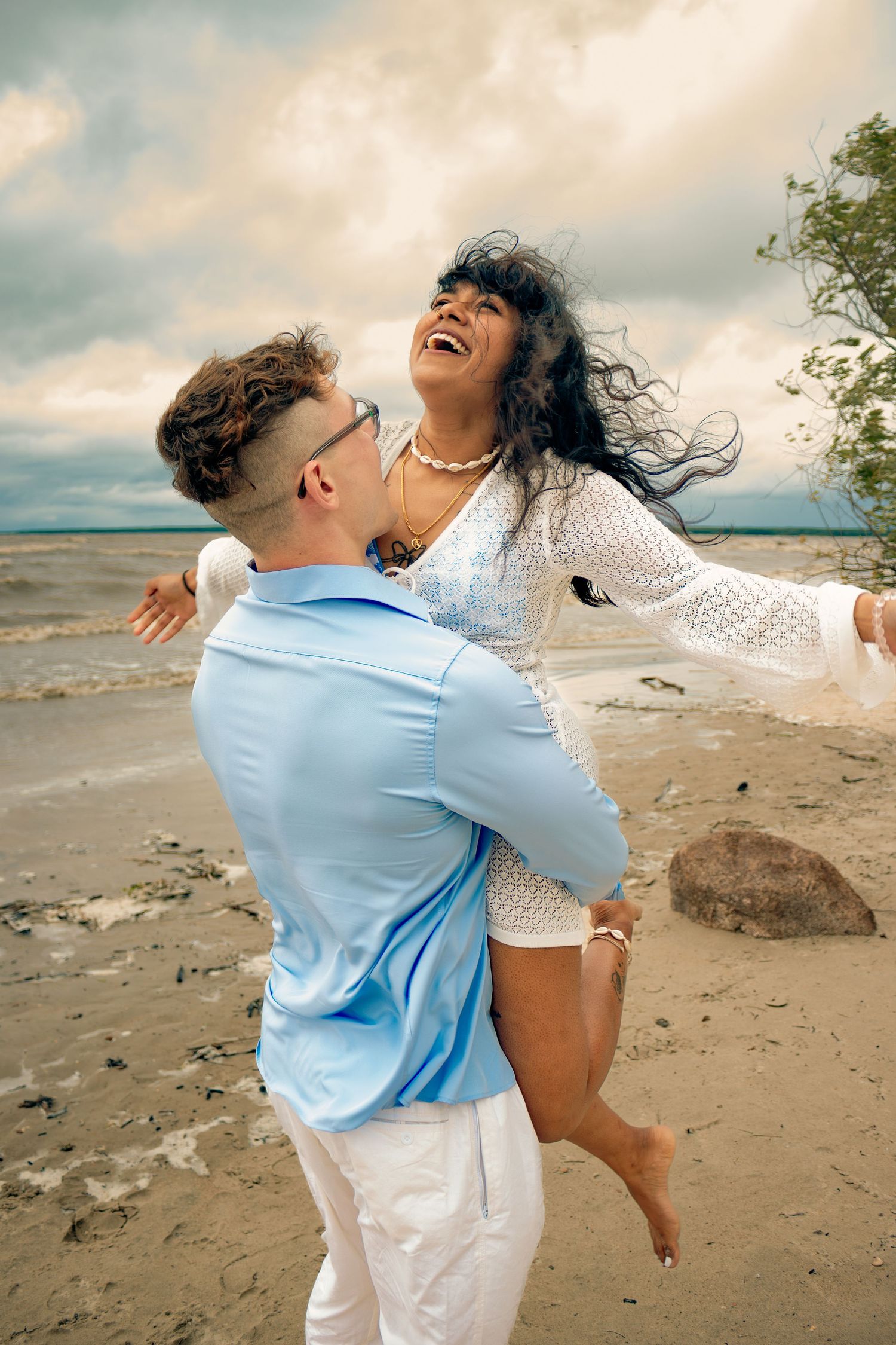 young couple posing at the beach