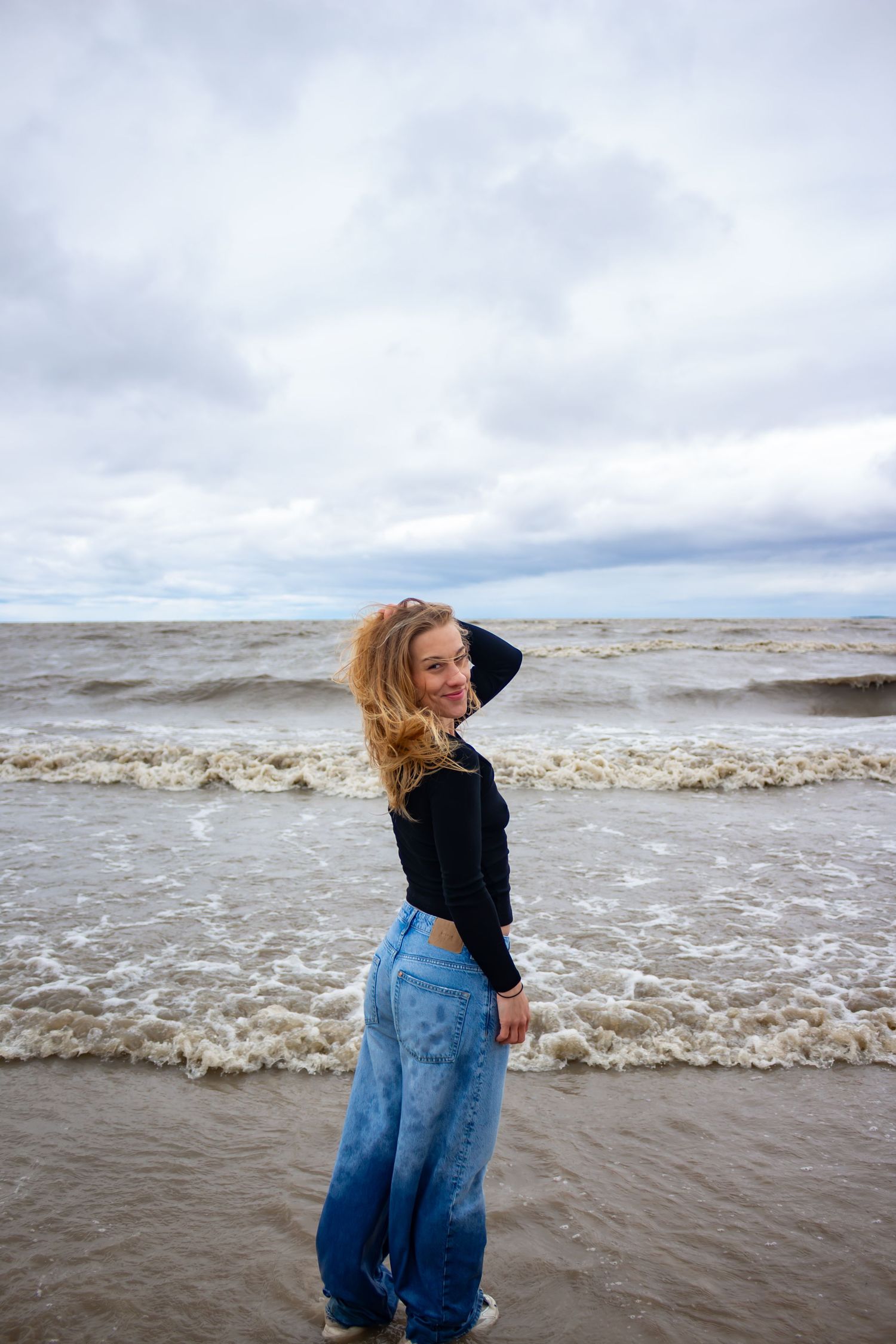young woman posing at the beach