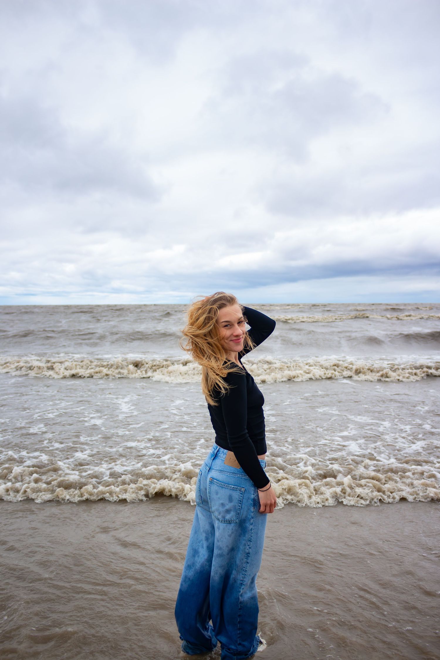 young woman posing at the beach
