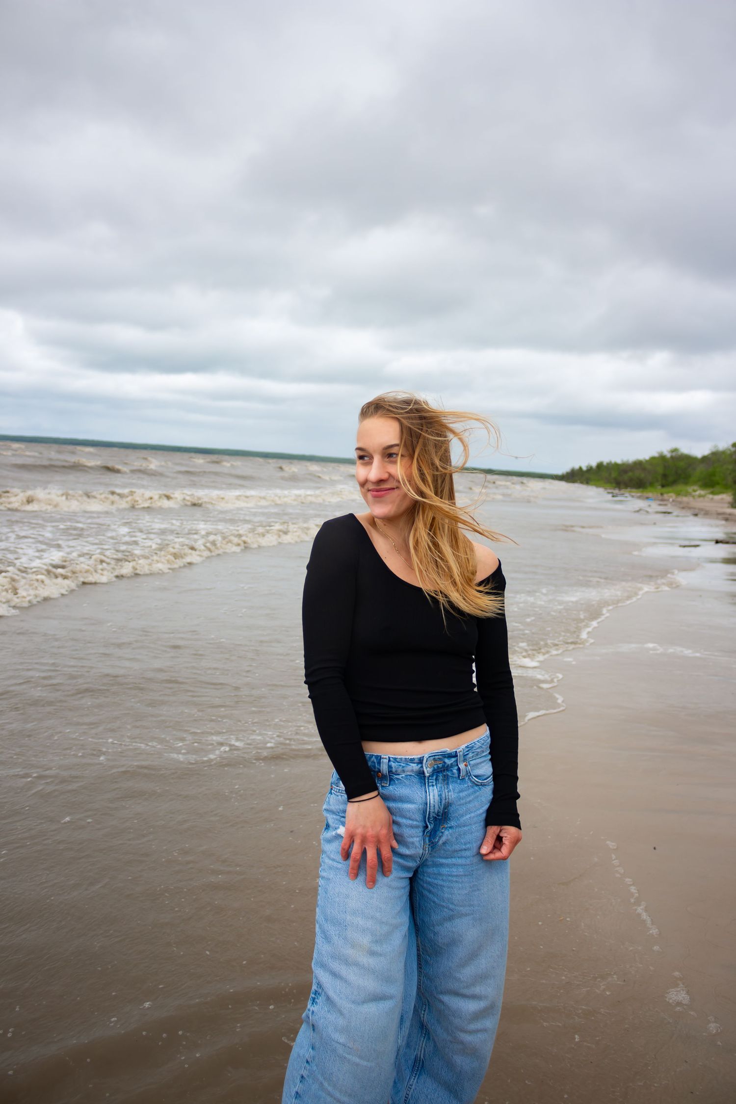 young woman posing at the beach