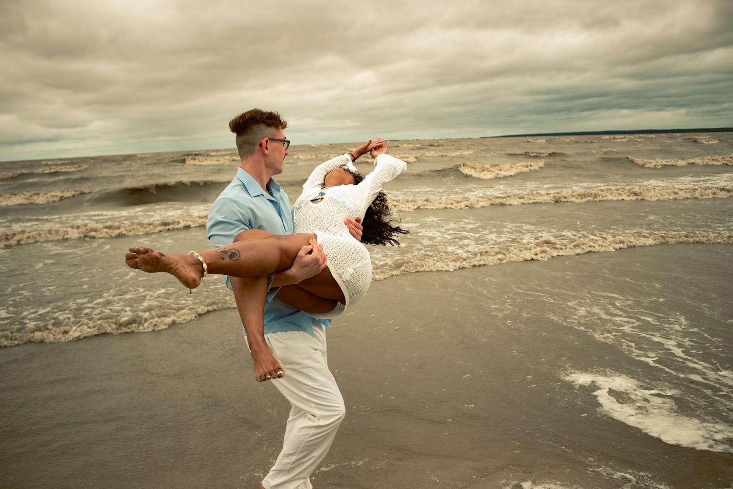 young couple posing at the beach