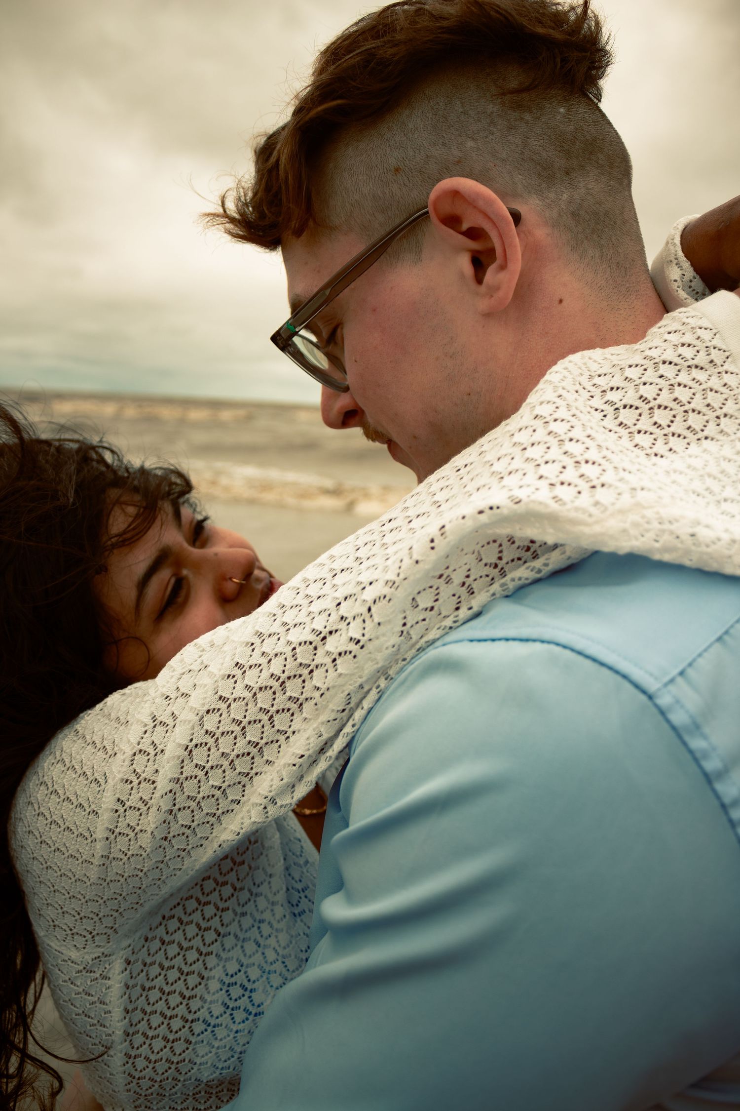 young couple posing at the beach