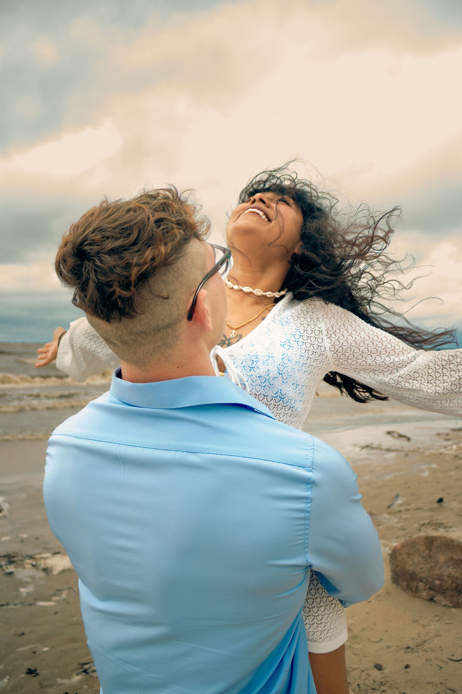 young couple posing at the beach