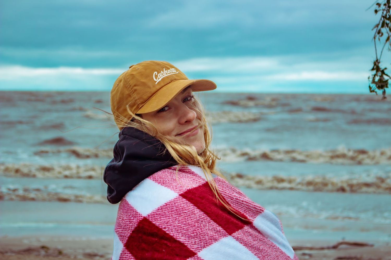 young woman posing at the beach