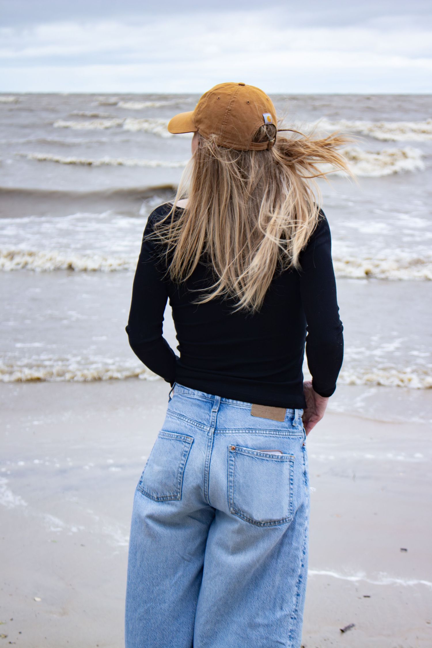 young woman posing at the beach