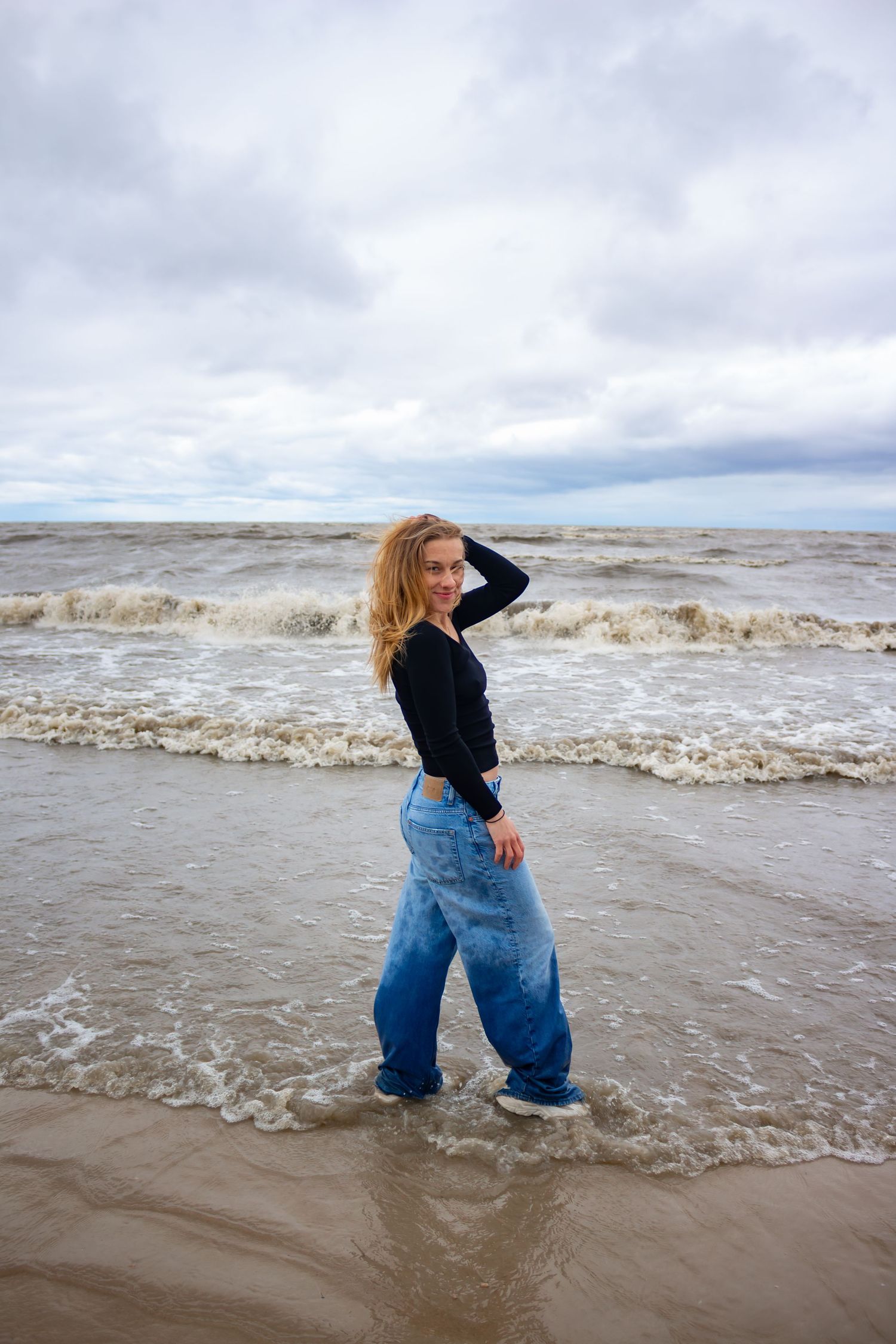 young woman posing at the beach
