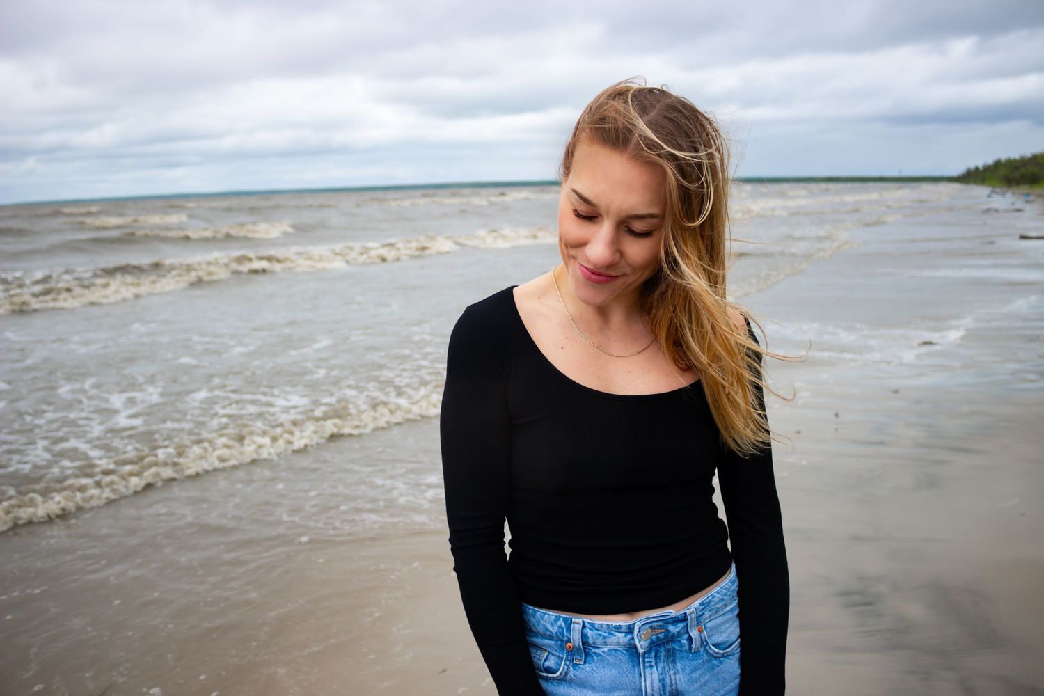 young woman posing at the beach