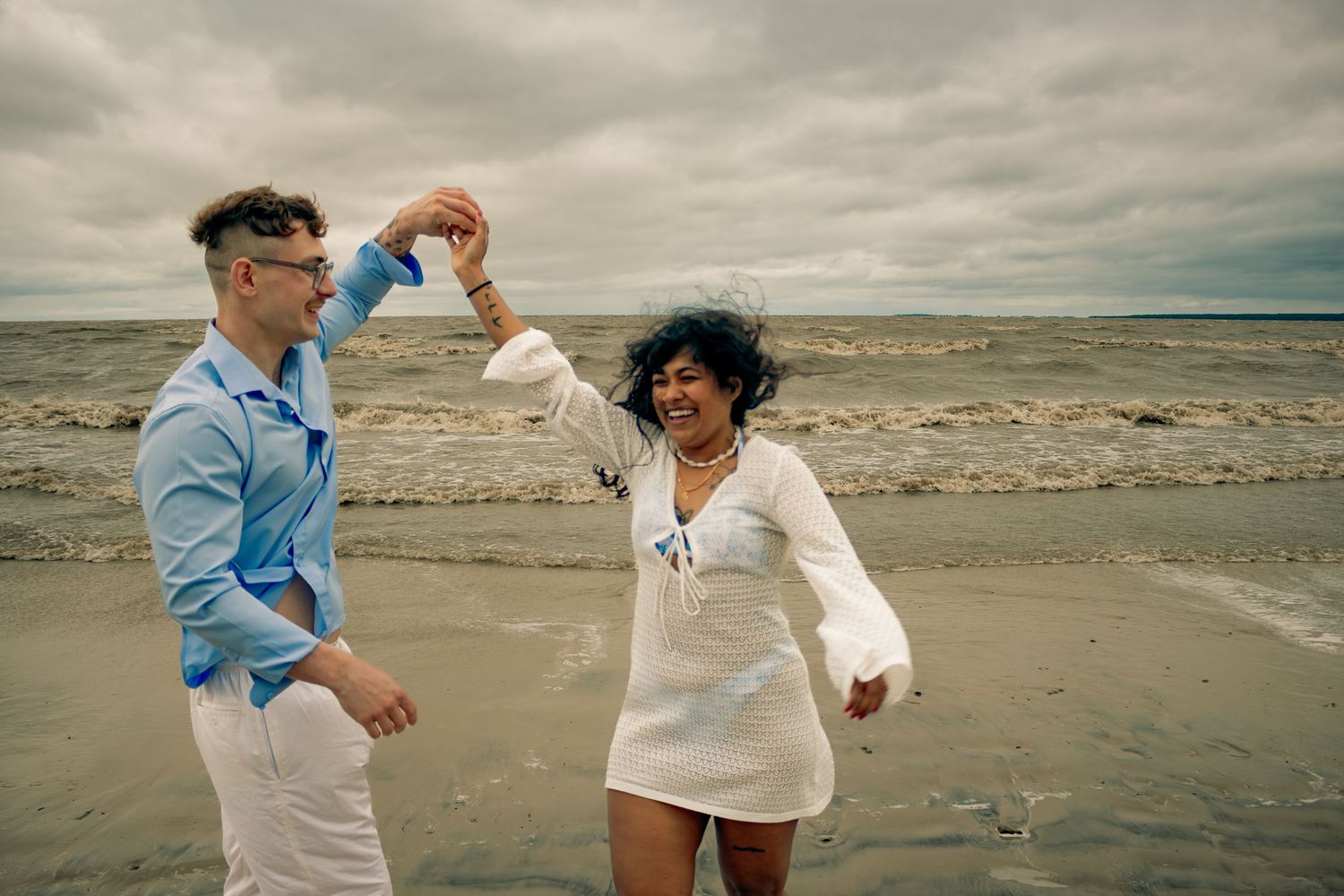 young couple posing at the beach