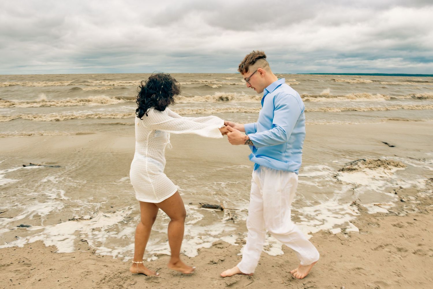 young couple posing at the beach