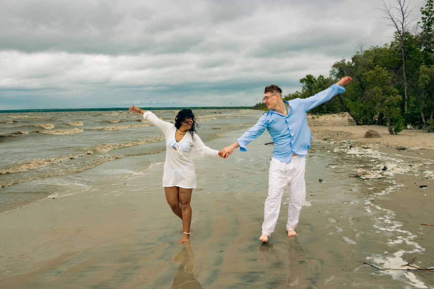 young couple posing at the beach