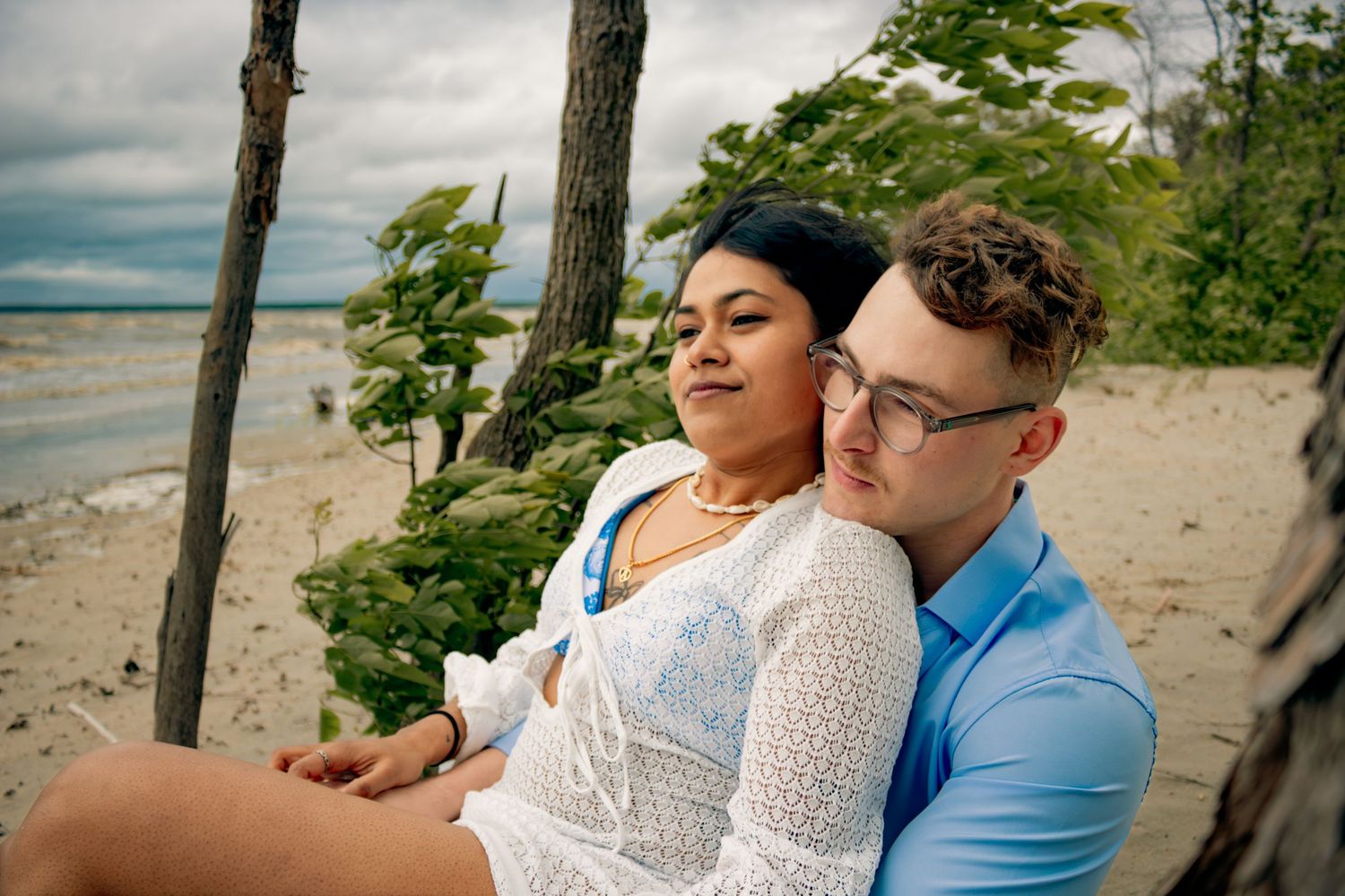 young couple posing at the beach