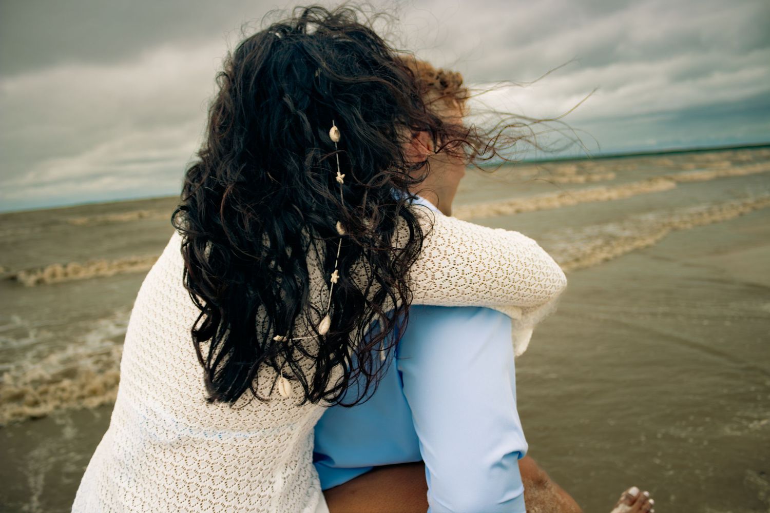 young couple posing at the beach