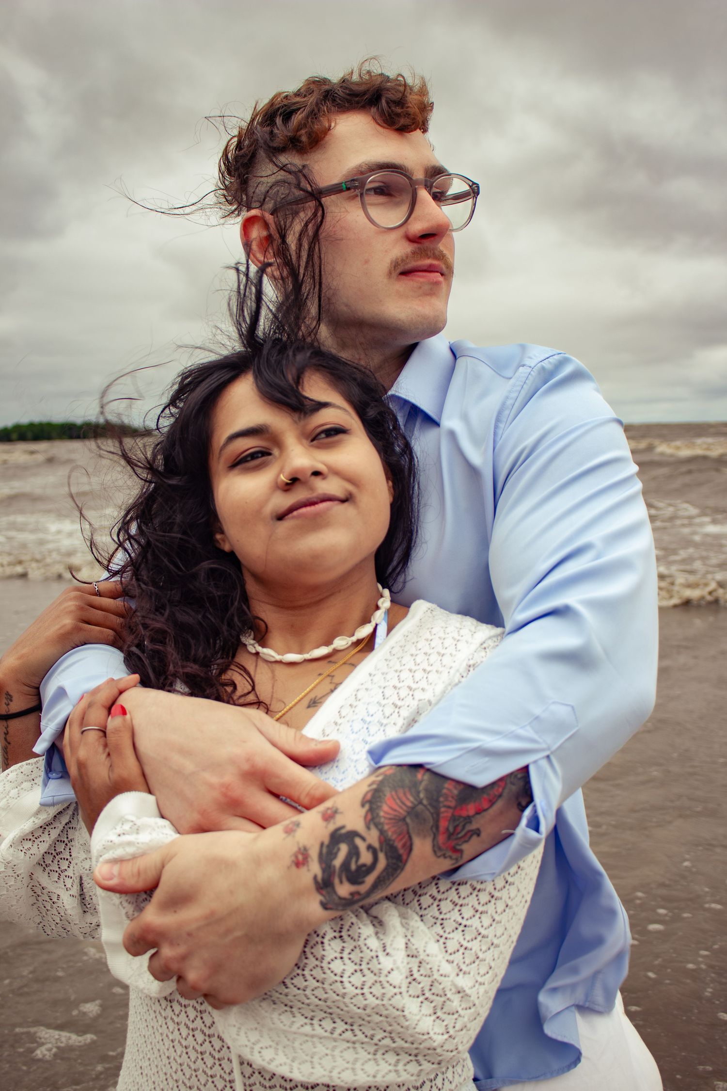 young couple posing at the beach