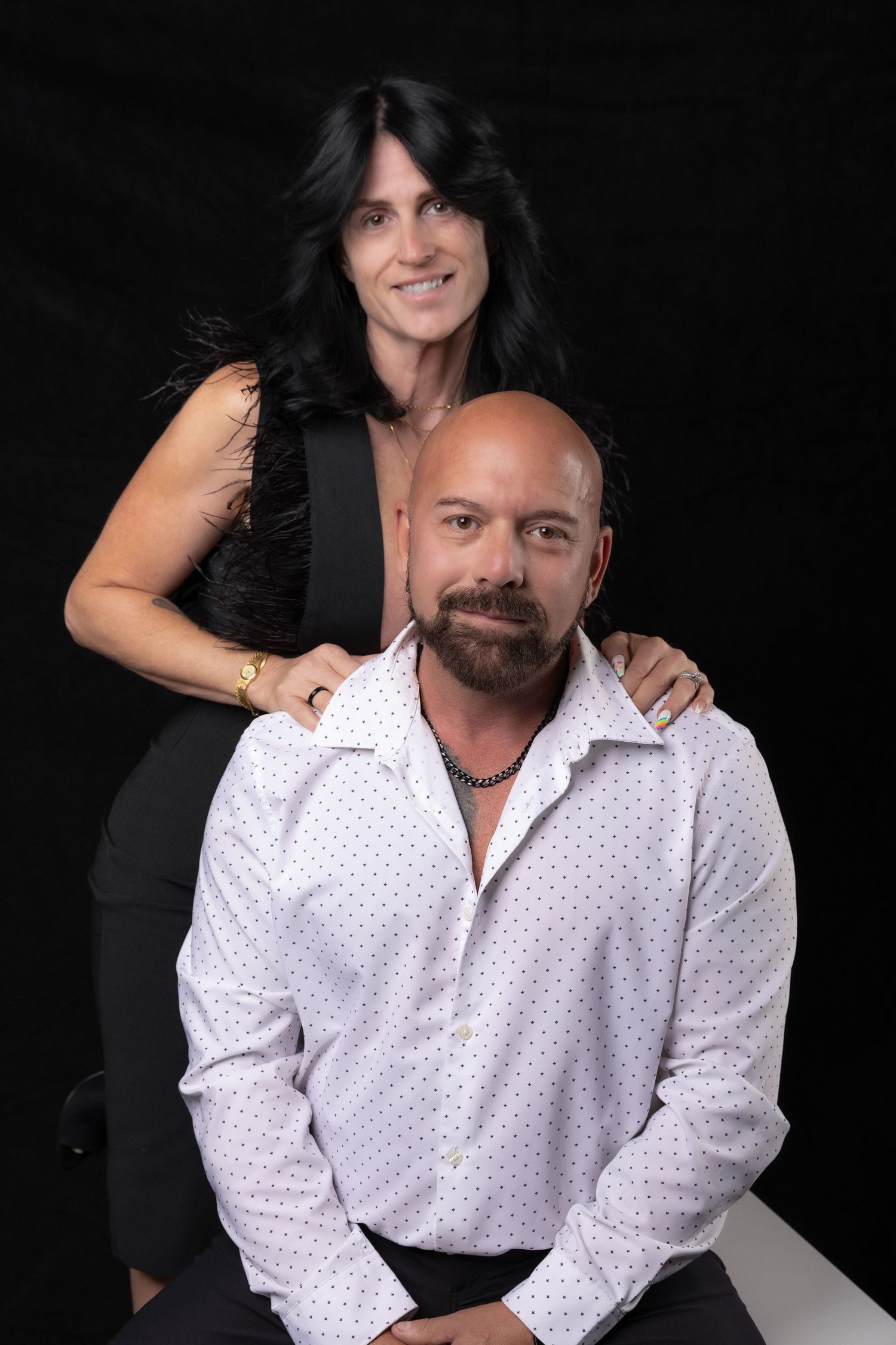 Elegant couples portraits in a studio featuring a couple in formal attire.