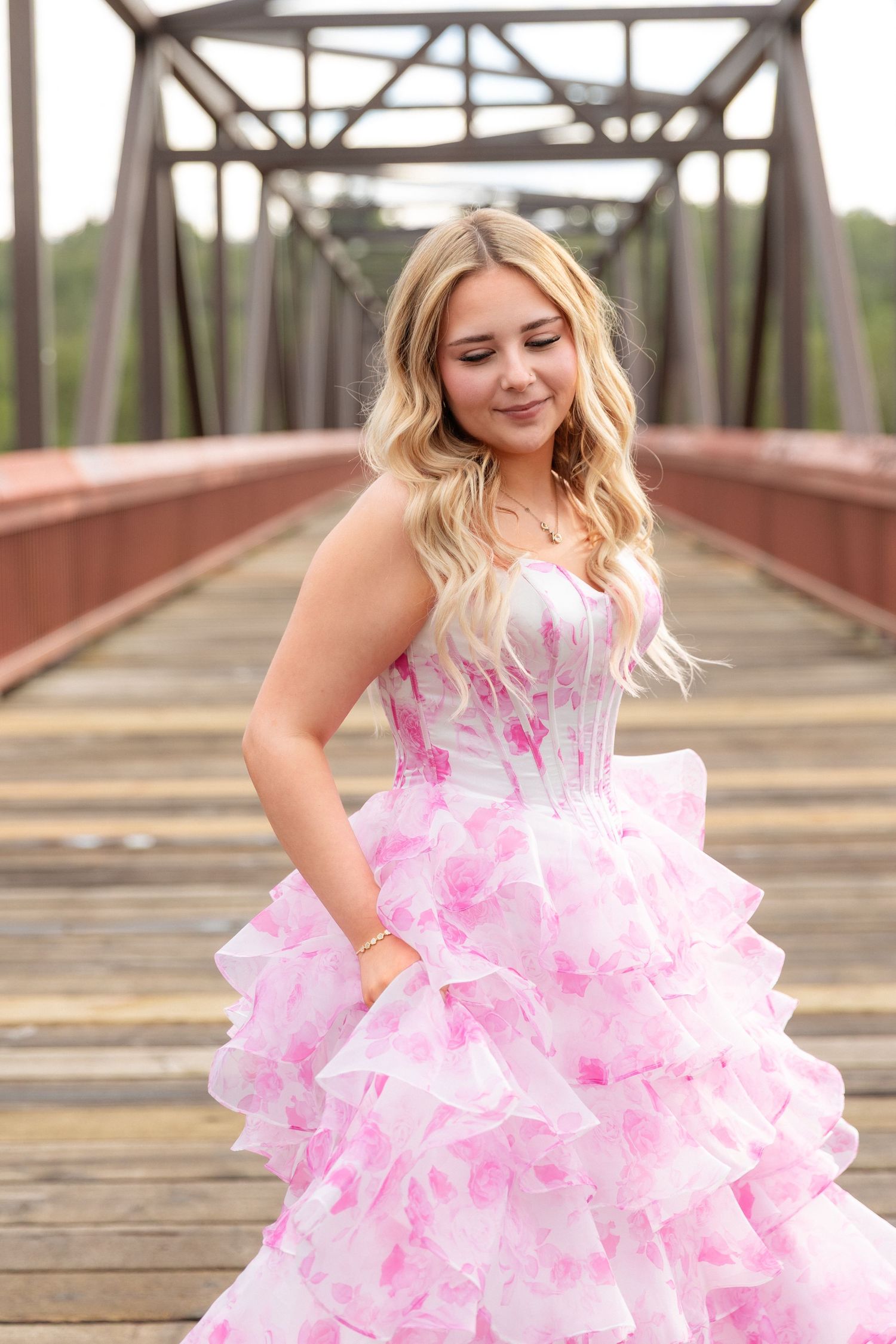 Graduate portrait session on a bridge in Rundle Park, Edmonton, Alberta.