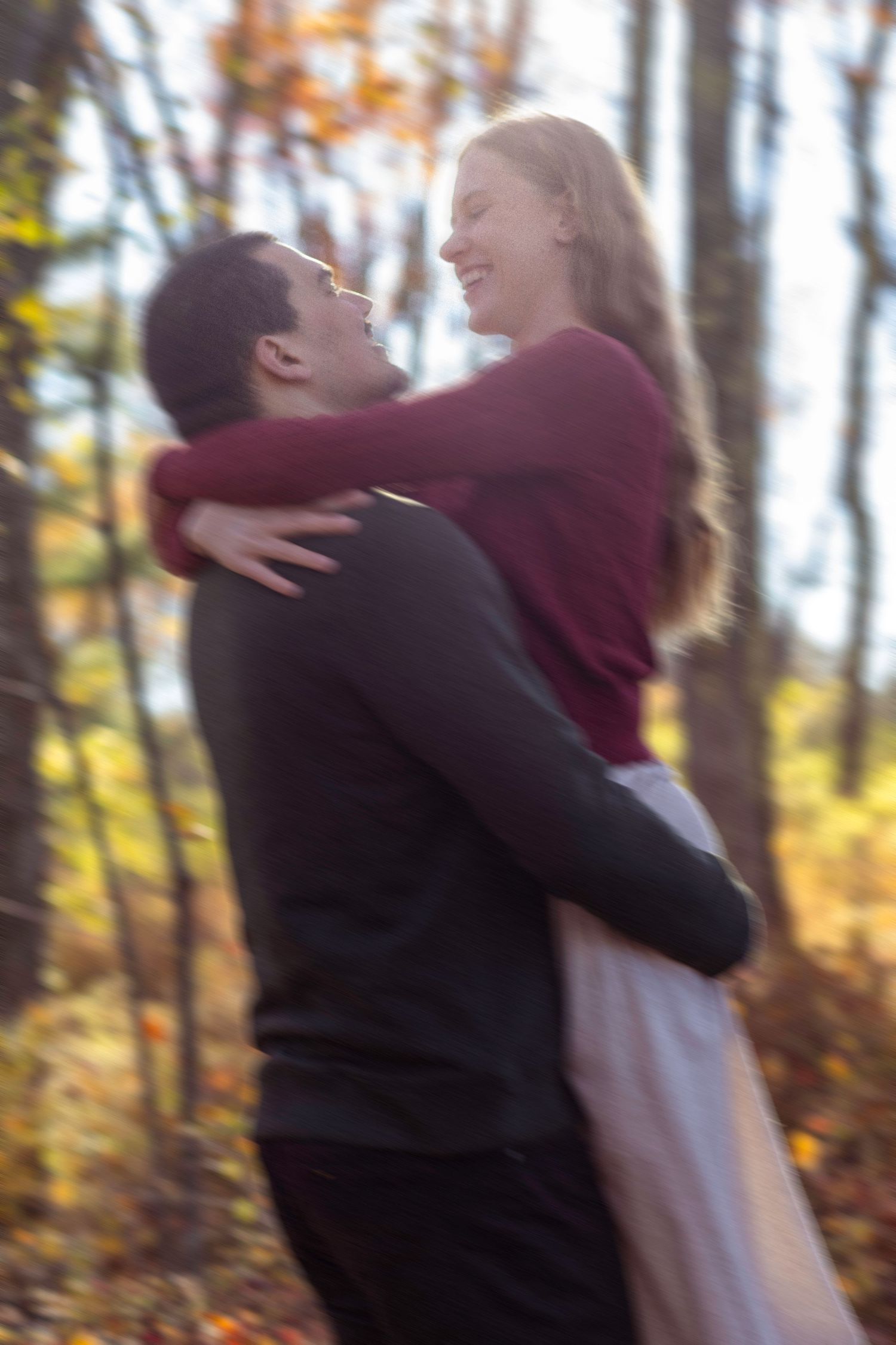 Couple twirling in the woods