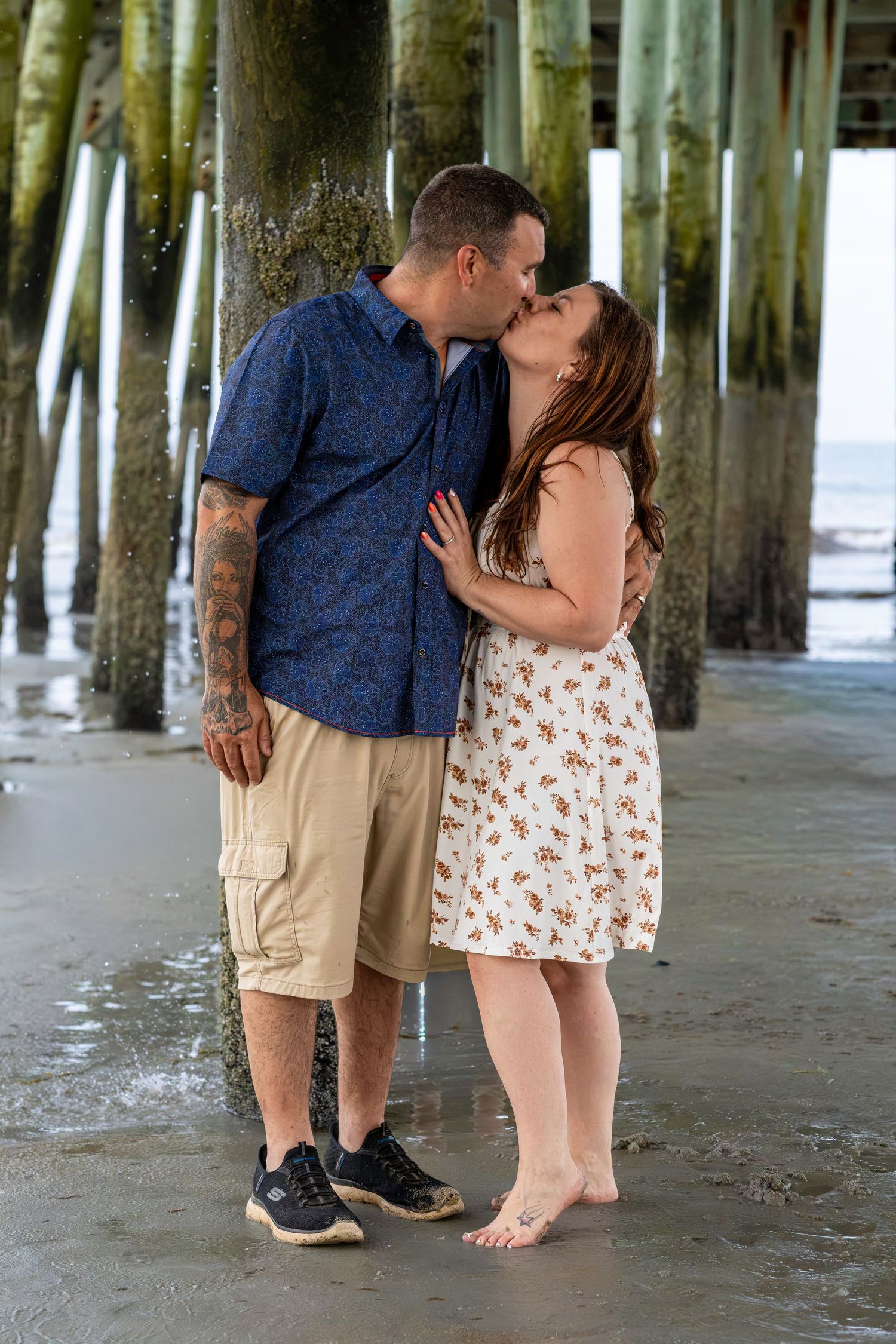Couple kissing under the pier