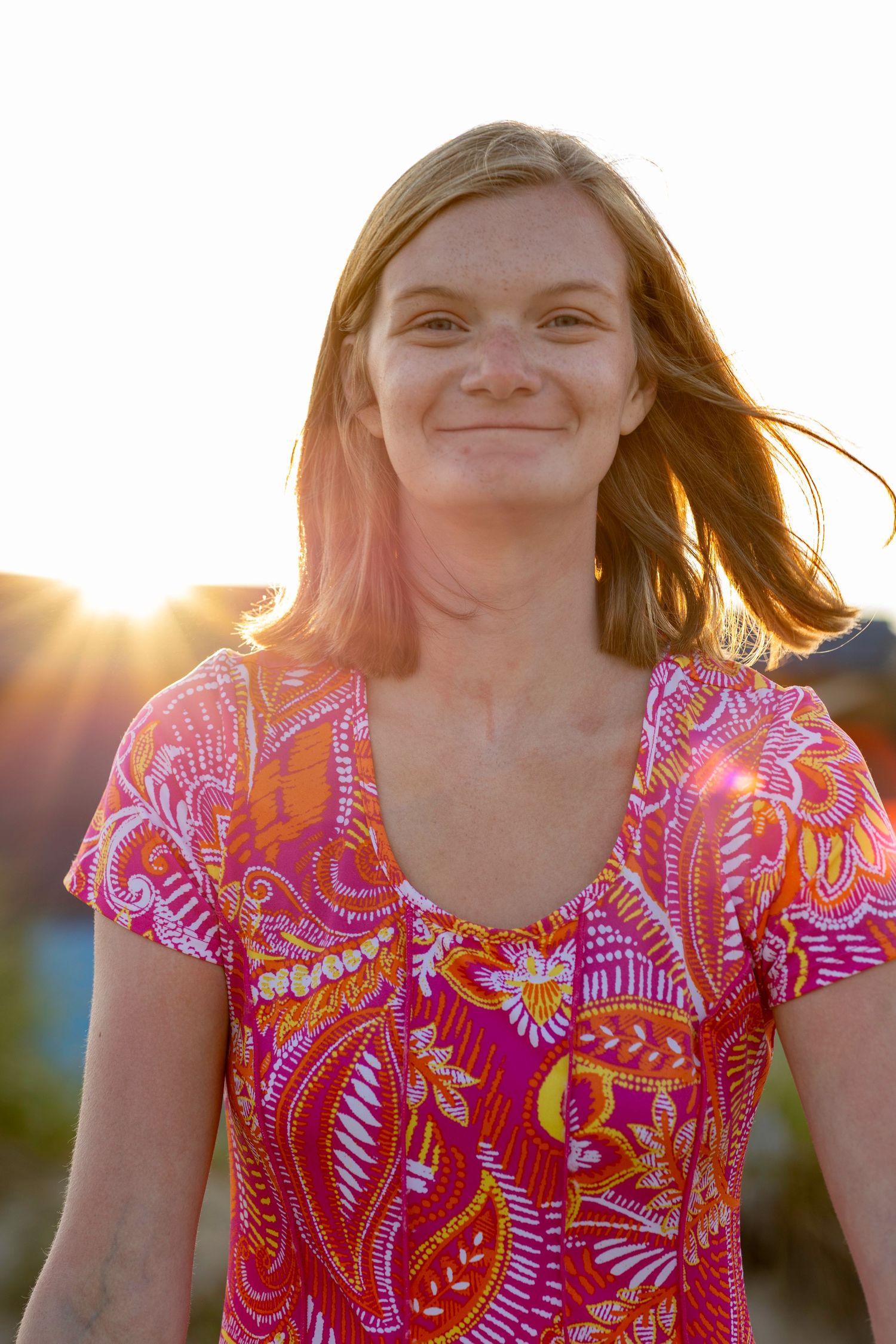 Portrait of a girl with the sun of to the left of her