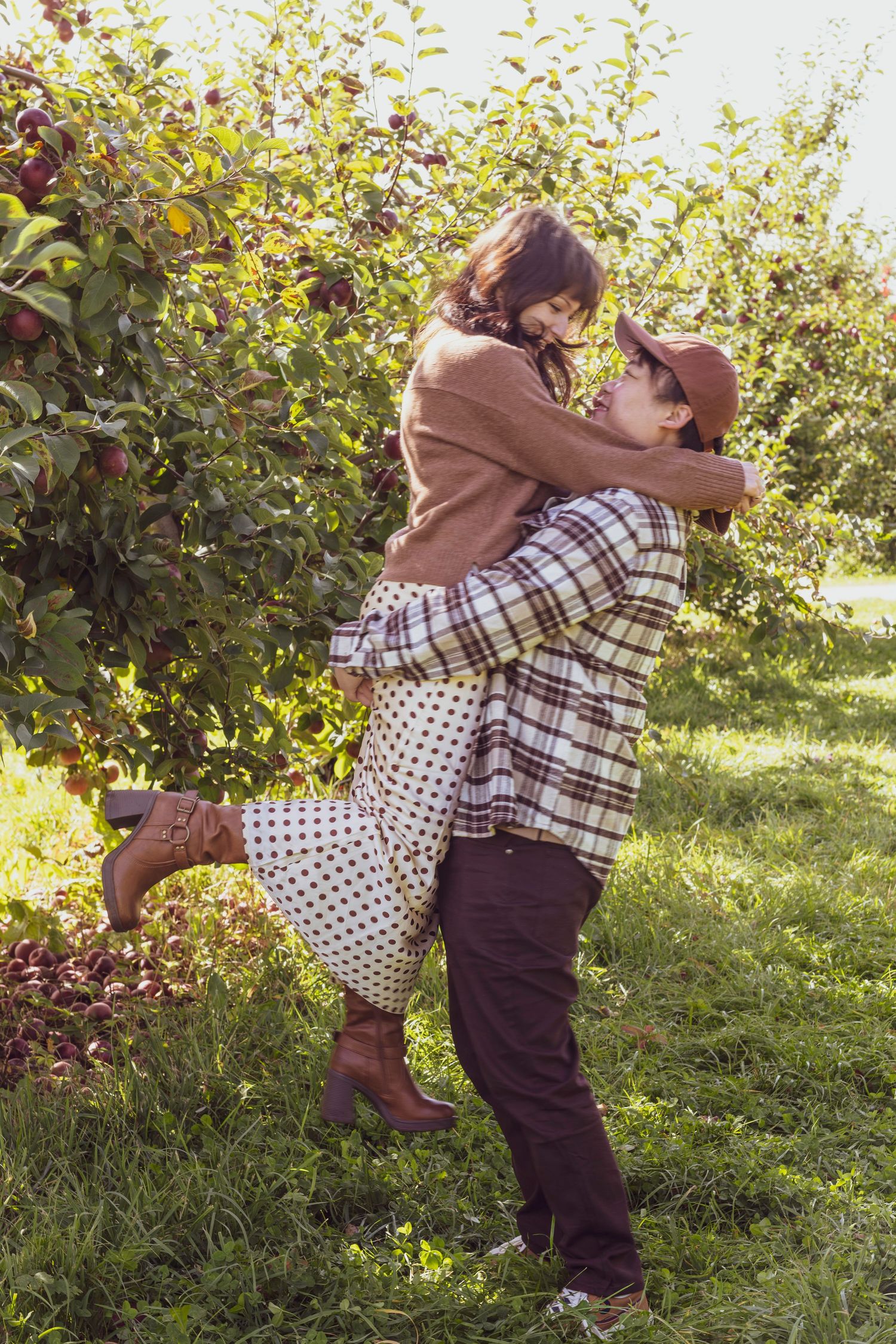 Couple in an apple orchard twirling