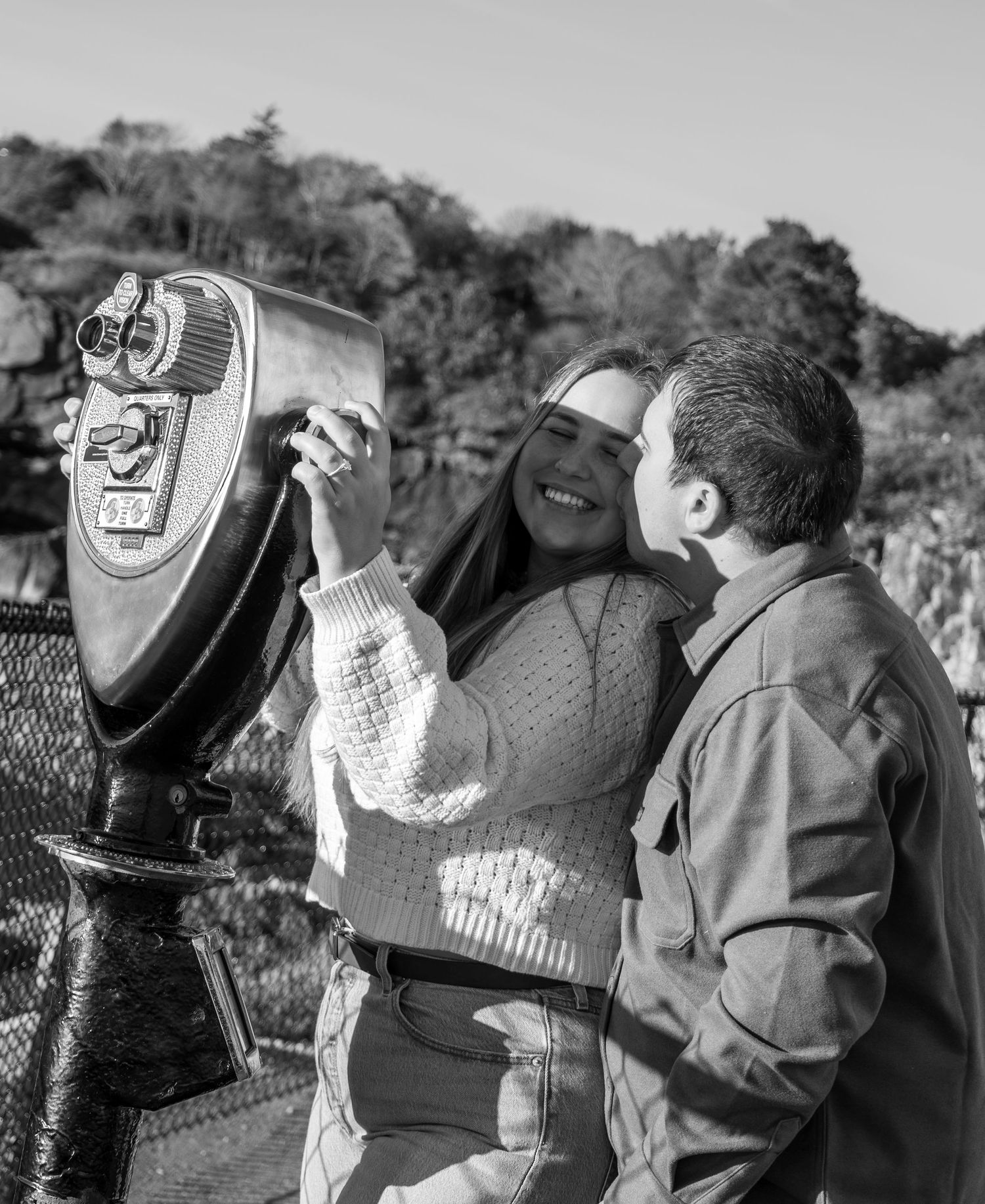Black and white photo of a couple looking through view finder