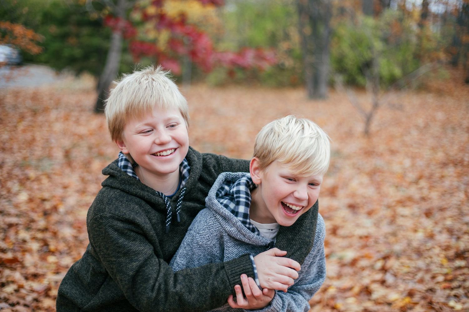 Brothers sharing a playful moment during an outdoor photography session in Île-Perrot